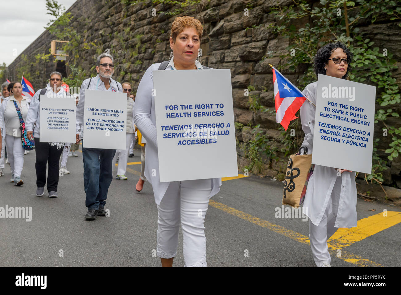 New York, United States. 23rd Sep, 2018. Hundreds of New Yorkers dressed in white participated on a silent procession through the streets of New York on September 23, 2018 to focus the nation's attention on this callous and craven neglect of U.S. Citizens in Puerto Rico still struggling for survival in the aftermath of Hurricane Maria. Participants walked 2.5 miles in unity, and in silence; from East Harlem to Trump Tower. Credit: Erik McGregor/Pacific Press/Alamy Live News Stock Photo