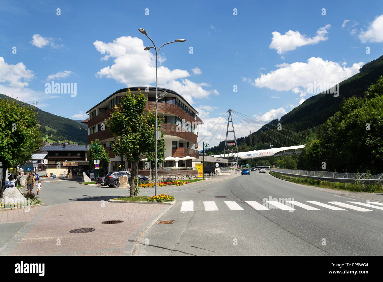 SAALBACH-HINTERGLEMM, AUSTRIA - JUNE 22 2018: People in front of Schattberg X-Press cable car over X-line bikers trail on June 22, 2018 in Saalbach-Hi Stock Photo