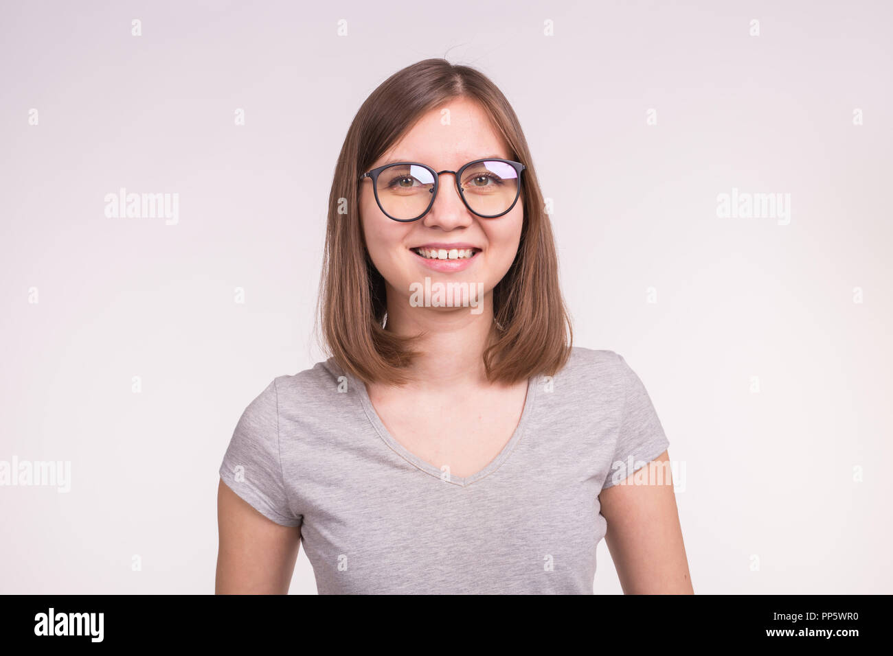 Portrait Of White Young Woman With Short Brown Hair In A Glasses