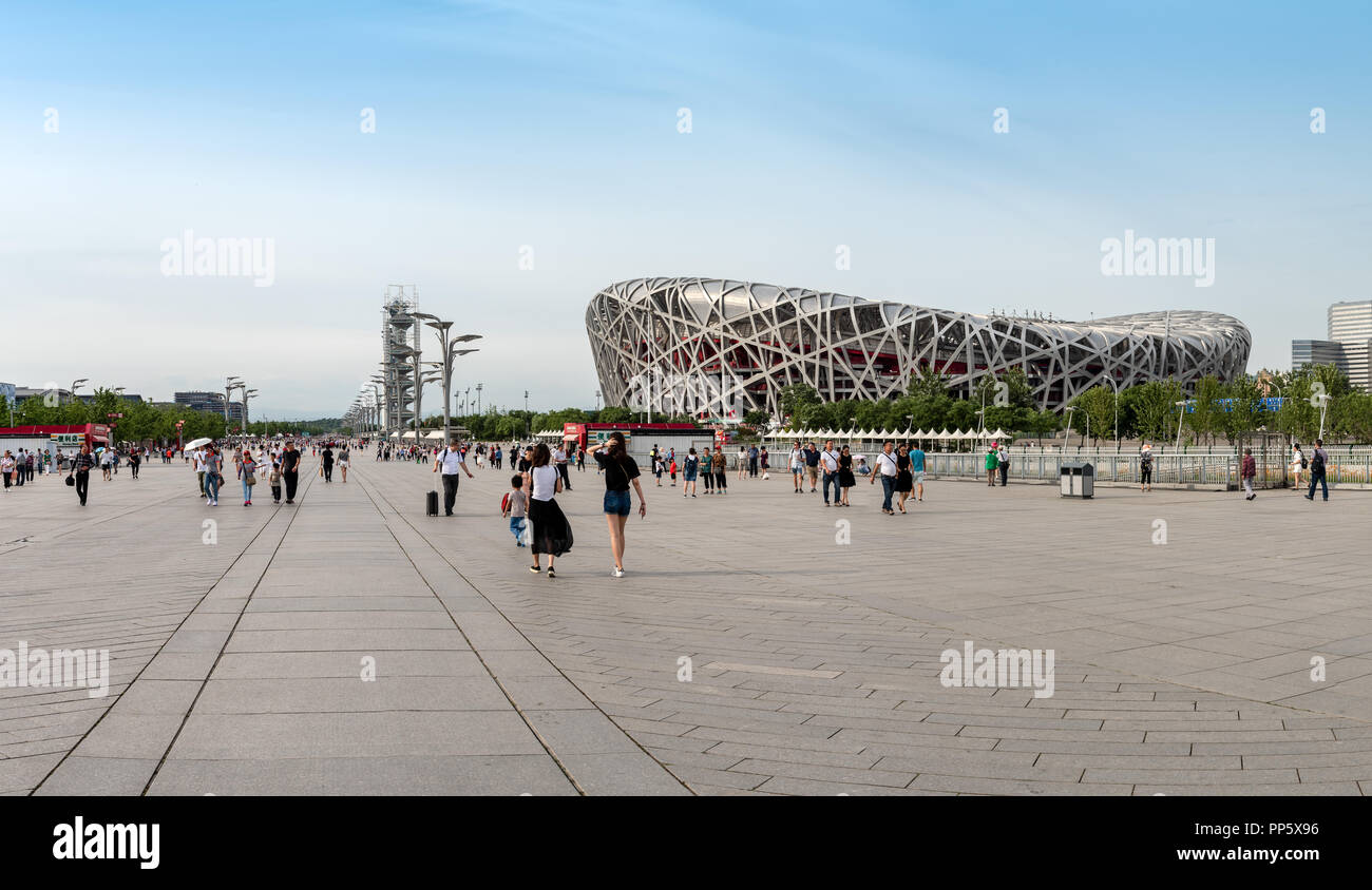 Panoramic image of People walking at the Olympic park near the birds nest stadium in Beijing China Stock Photo