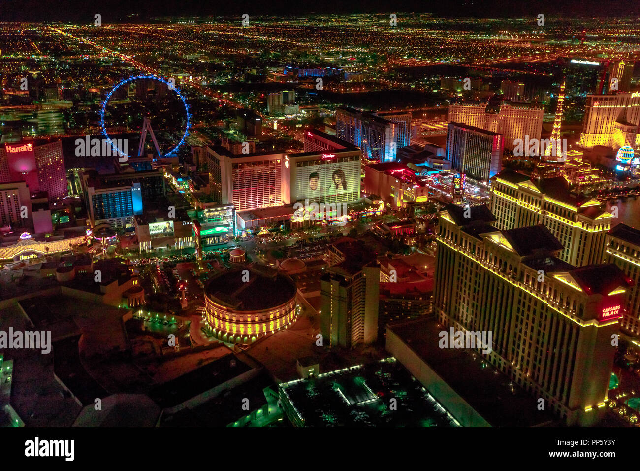 Las Vegas, Nevada, United States - August 18, 2018: aerial view of Las Vegas  Strip Skyline illuminated by night. Scenic flight above: High Roller,  Caesars Palace, Flamingo, The Paris Casino and Hotel
