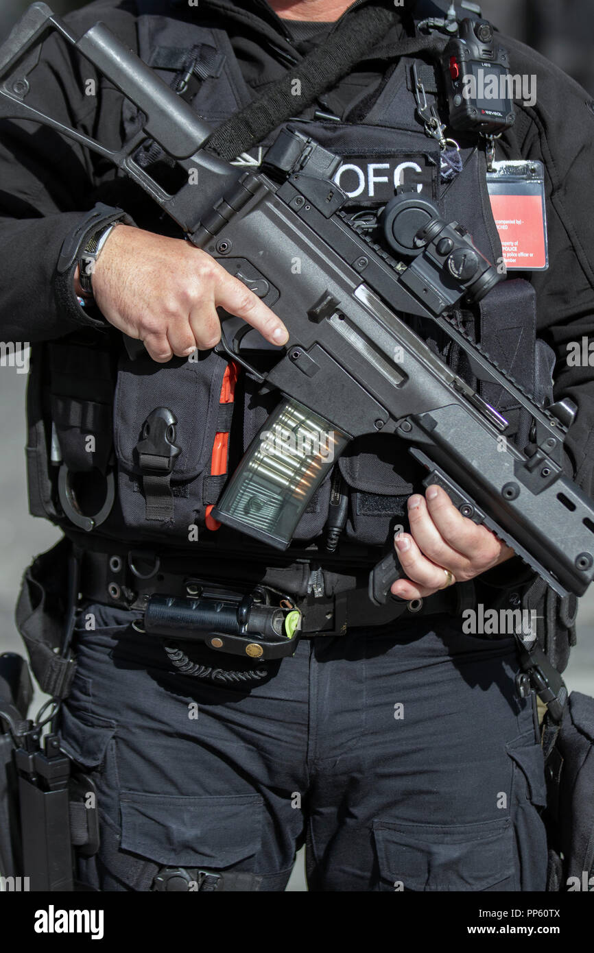 Authorised firearms officer (AFO)  a British police officer in Liverpool, UK.  Weapons, policing, police, uniform, british, force, officer, law, armed, security, control, england, patrol, gun, weapon, firearm, military, handgun, pistol, security, crime, protection, patrol, enforcement, cop, crime, shot, danger, black uniforms, firearms and equipment of British Armed Police on duty at the Labour Party Annual Conference, 2018. Stock Photo