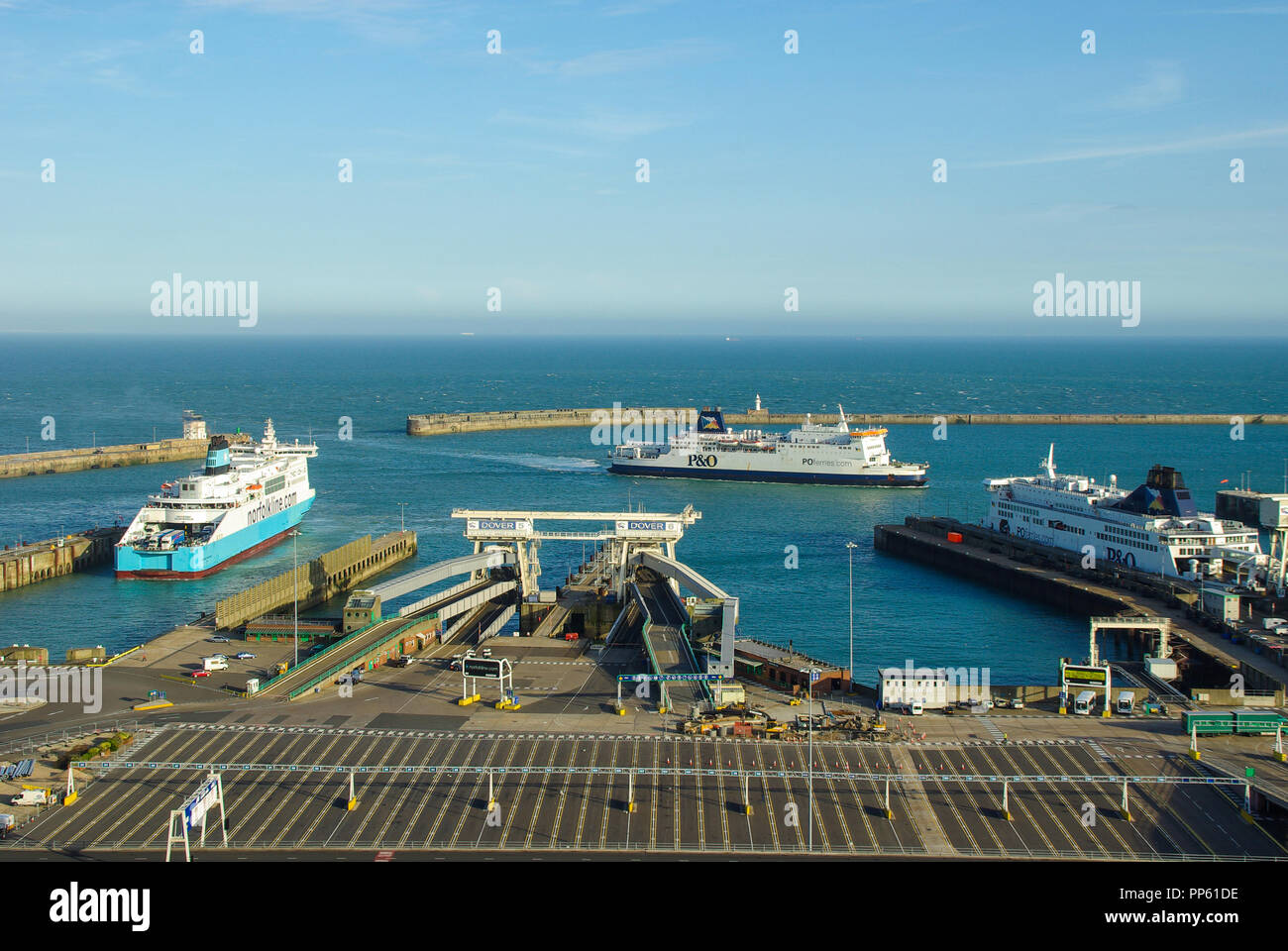 Port of Dover with NorfolkLine and P&O Ferries ferry ships, vessels. Dover Harbour with the English Channel on a blue sky sunny day Stock Photo