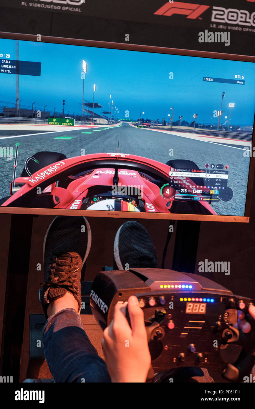 Visitors in the driving simulator F1 2018 at the world's largest fair for computer and video games Gamescom in Cologne, Germany on 24.8.2018 Stock Photo