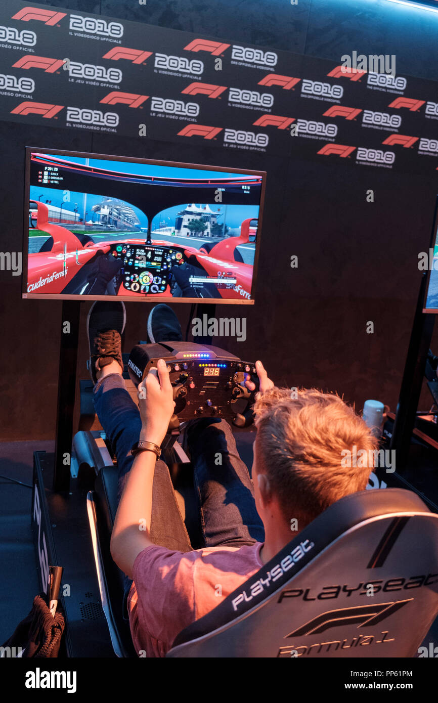 Visitors in the driving simulator F1 2018 at the world's largest fair for computer and video games Gamescom in Cologne, Germany on 24.8.2018 Stock Photo