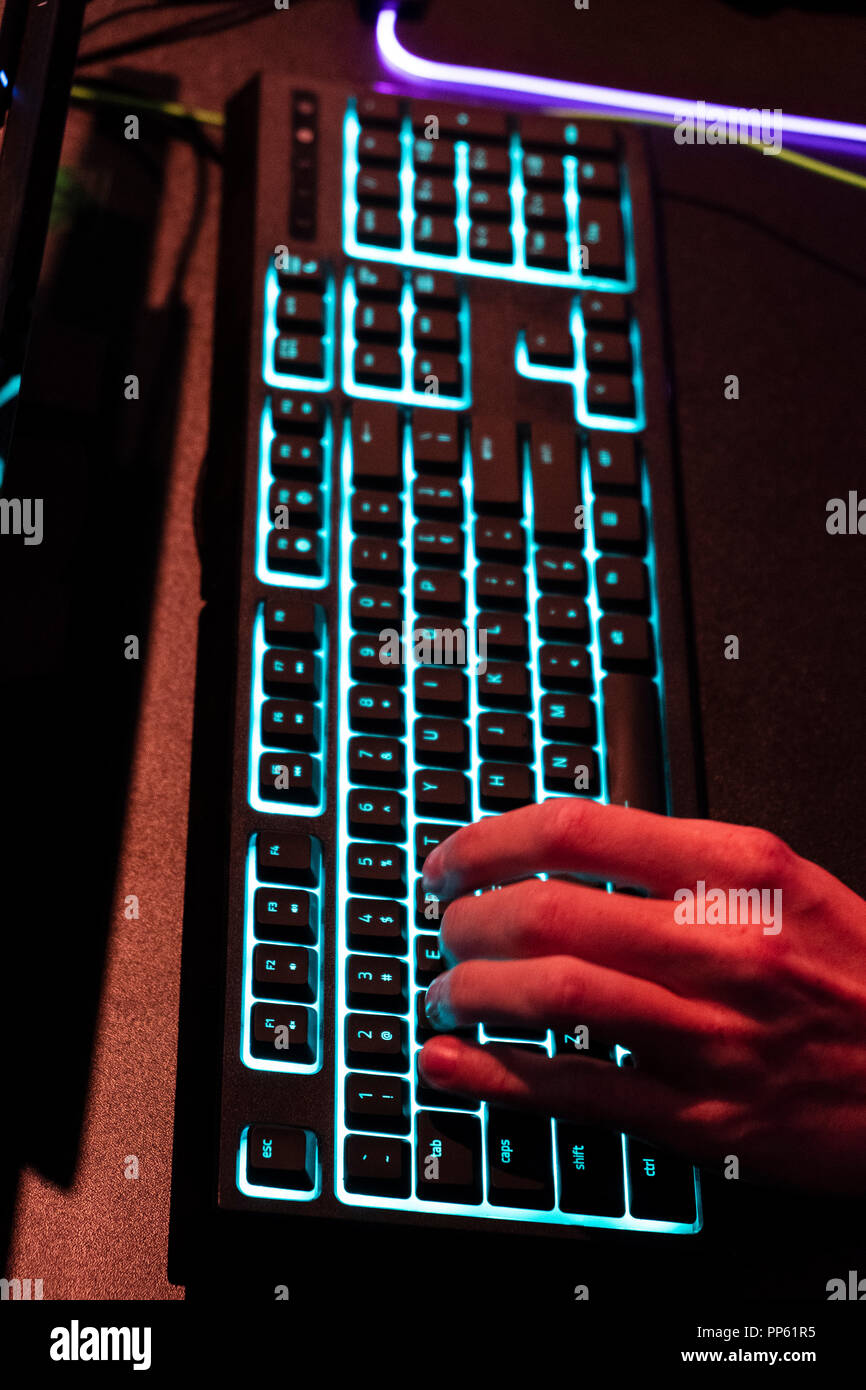 hand on illuminated keyboard at the world's largest fair for computer