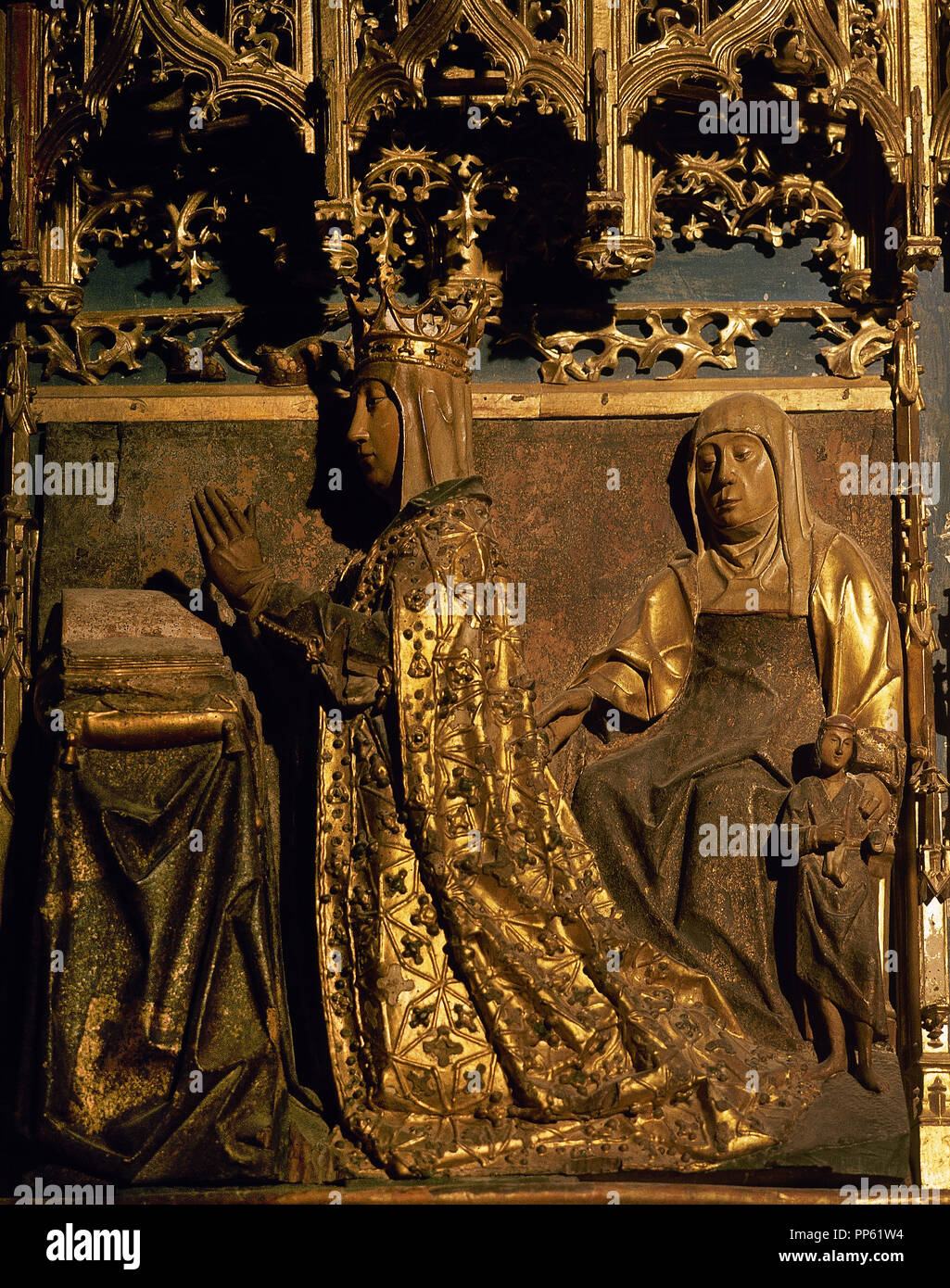 Spain. Castile and Leon. Burgos. MIraflores Charterhouse. Altarpiece which  was carved in 1496-1499 by Castilian sculptor of Flemish origin Gil de Siloe (1440-1501), and polychromed and gilded by Diego de la Cruz (1482-1500), a Flemish origin painter.  Detail of Isabel of Portugal, queen consort of Castile, 1447-1454, praying and protected by her patron Saint ( St. Elizabeth). Stock Photo