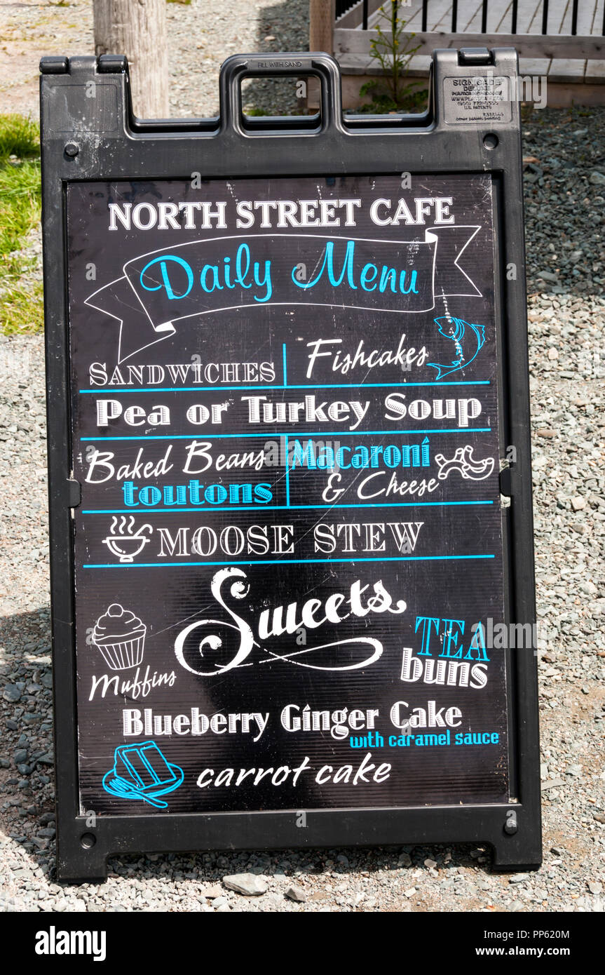 Menu on a blackboard outside a Newfoundland cafe featuring local food such as Toutons and Moose Stew. Stock Photo