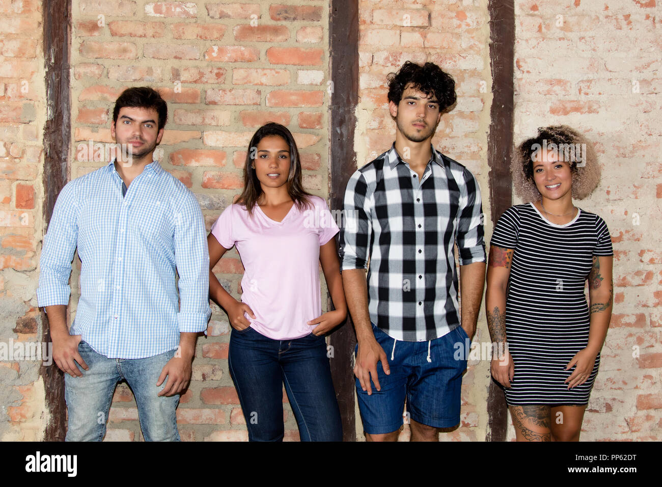 Group of smart young people in casual clothes looking at camera Stock Photo