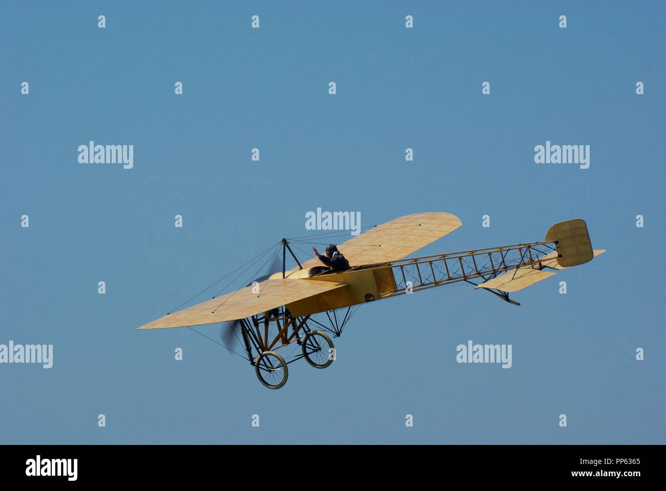 Flying Bleriot XI replica built in Sweden by Mikael Carlsson. Pioneer flying machine by Louis Bleriot from the early days of flight. Blue sky Stock Photo