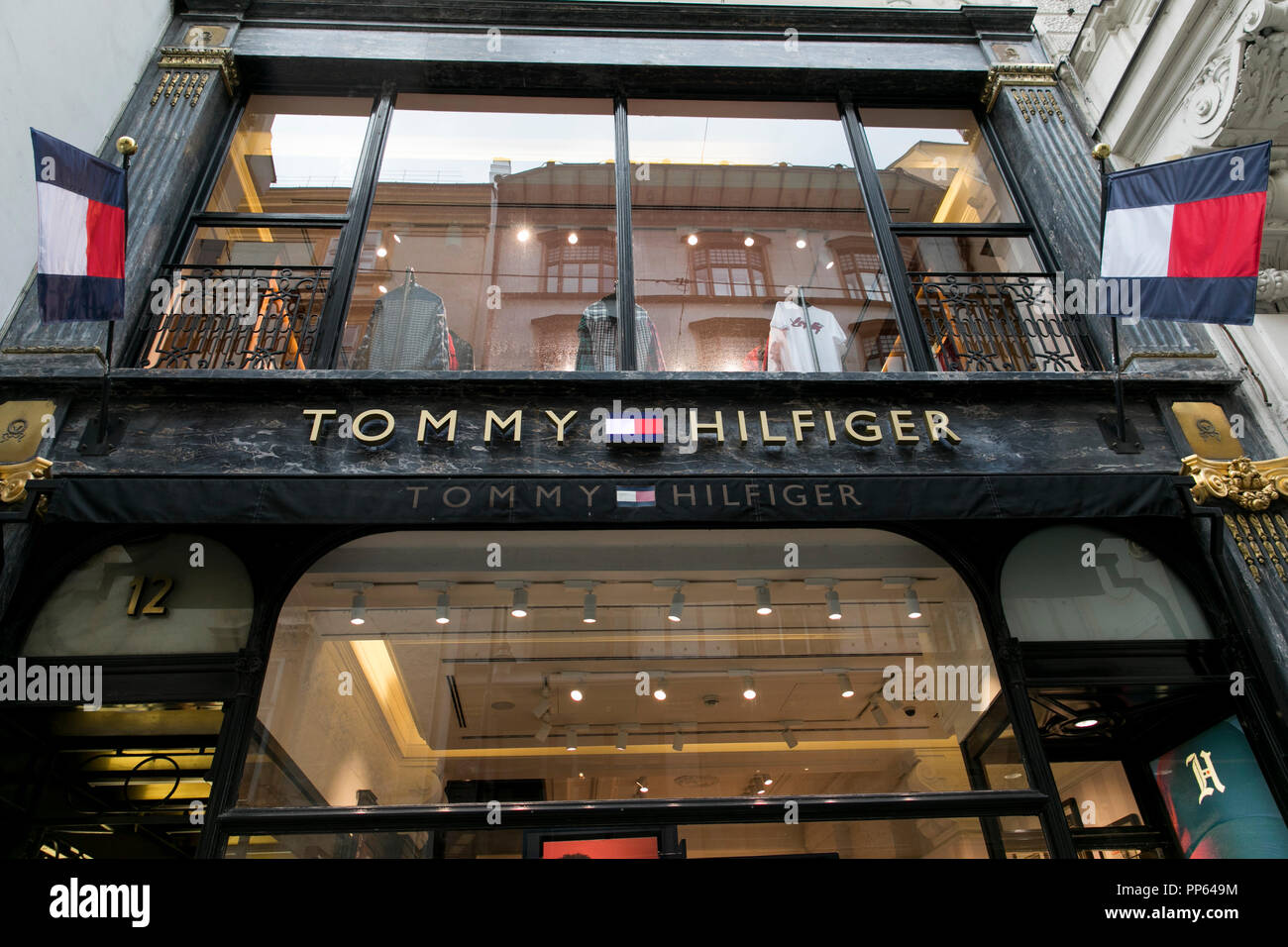 A logo sign outside of a Tommy Hilfiger retail store location in