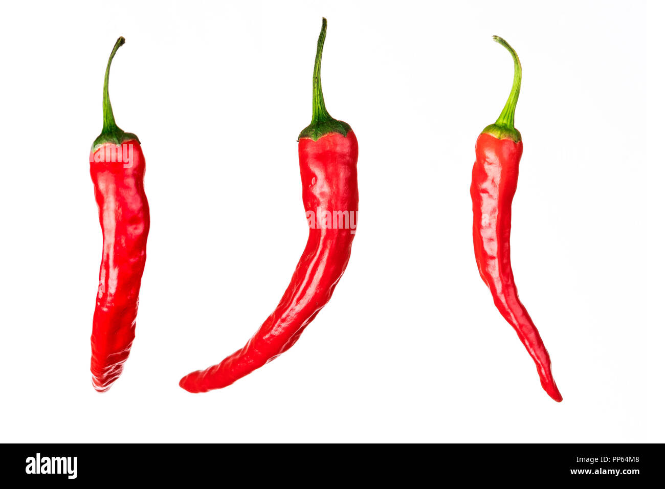 three pieces of red chili peppers isolated on white background Stock Photo