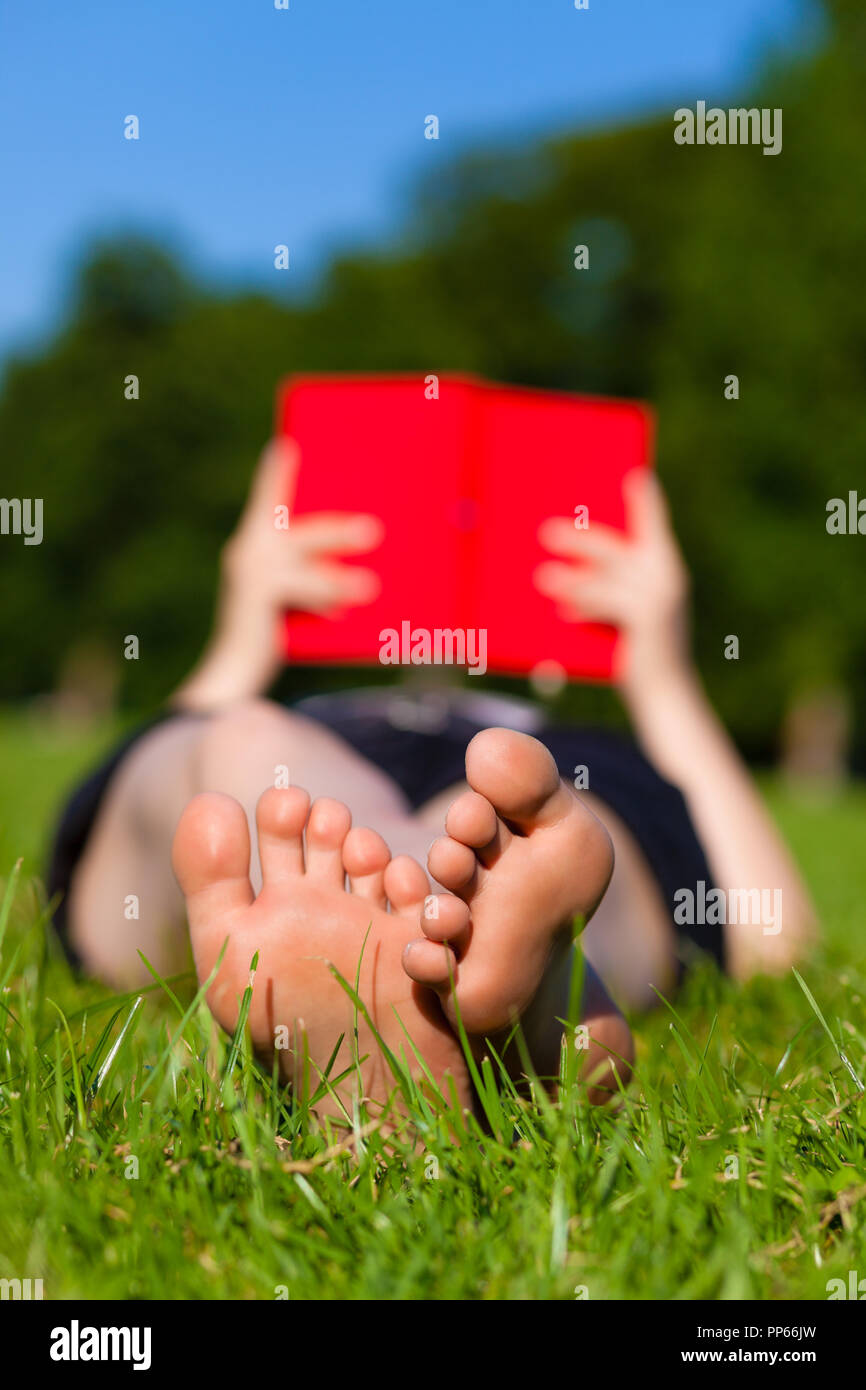 Woman feet while reading a book Stock Photo Alamy