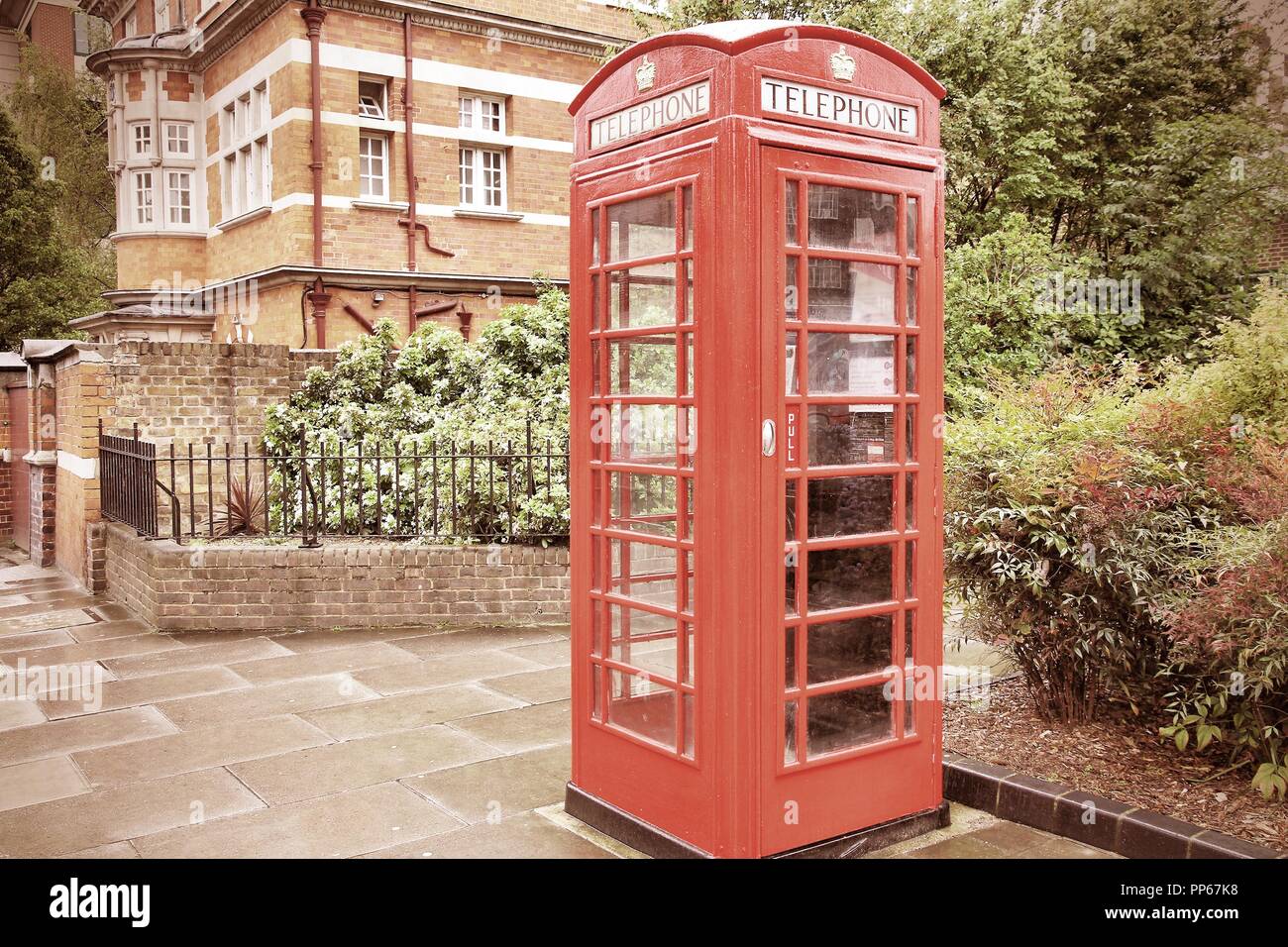 London, United Kingdom red telephone box closeup. Cross processing