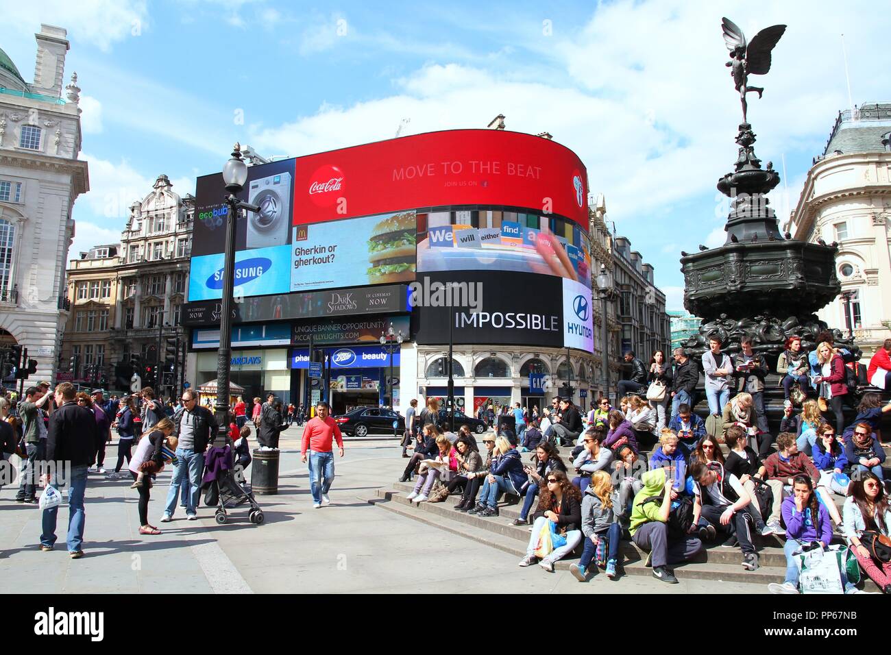 LONDON, UK - MAY 13, 2012: People visit Piccadilly Circus in London. With more than 14 million international arrivals in 2009, London is the most visi Stock Photo