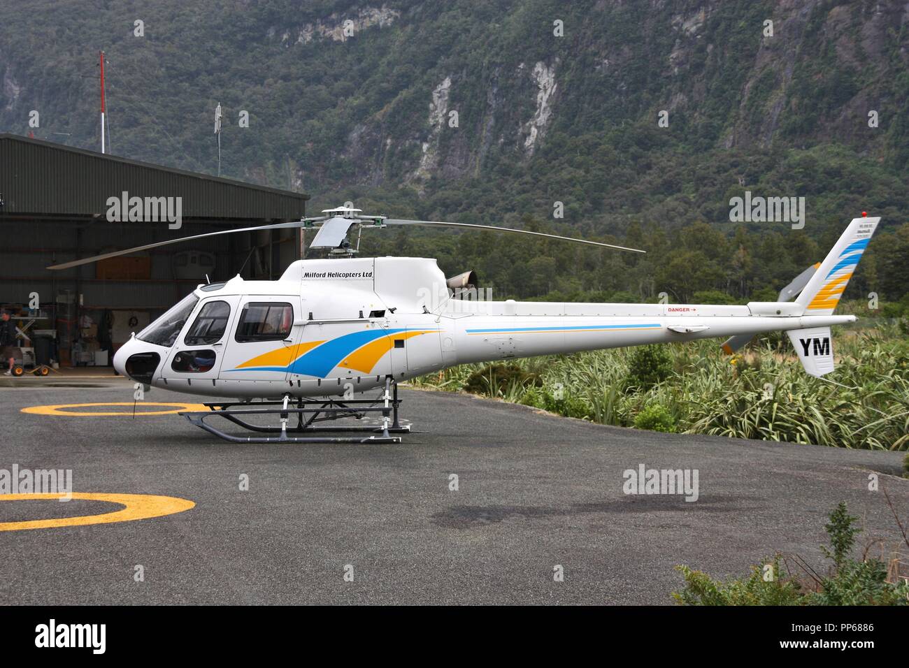 MILFORD SOUND, NEW ZEALAND - FEBRUARY 26: Eurocopter AS350 parked on February 26, 2008 in Milford Sound, New Zealand. AS350 is on of most successful h Stock Photo