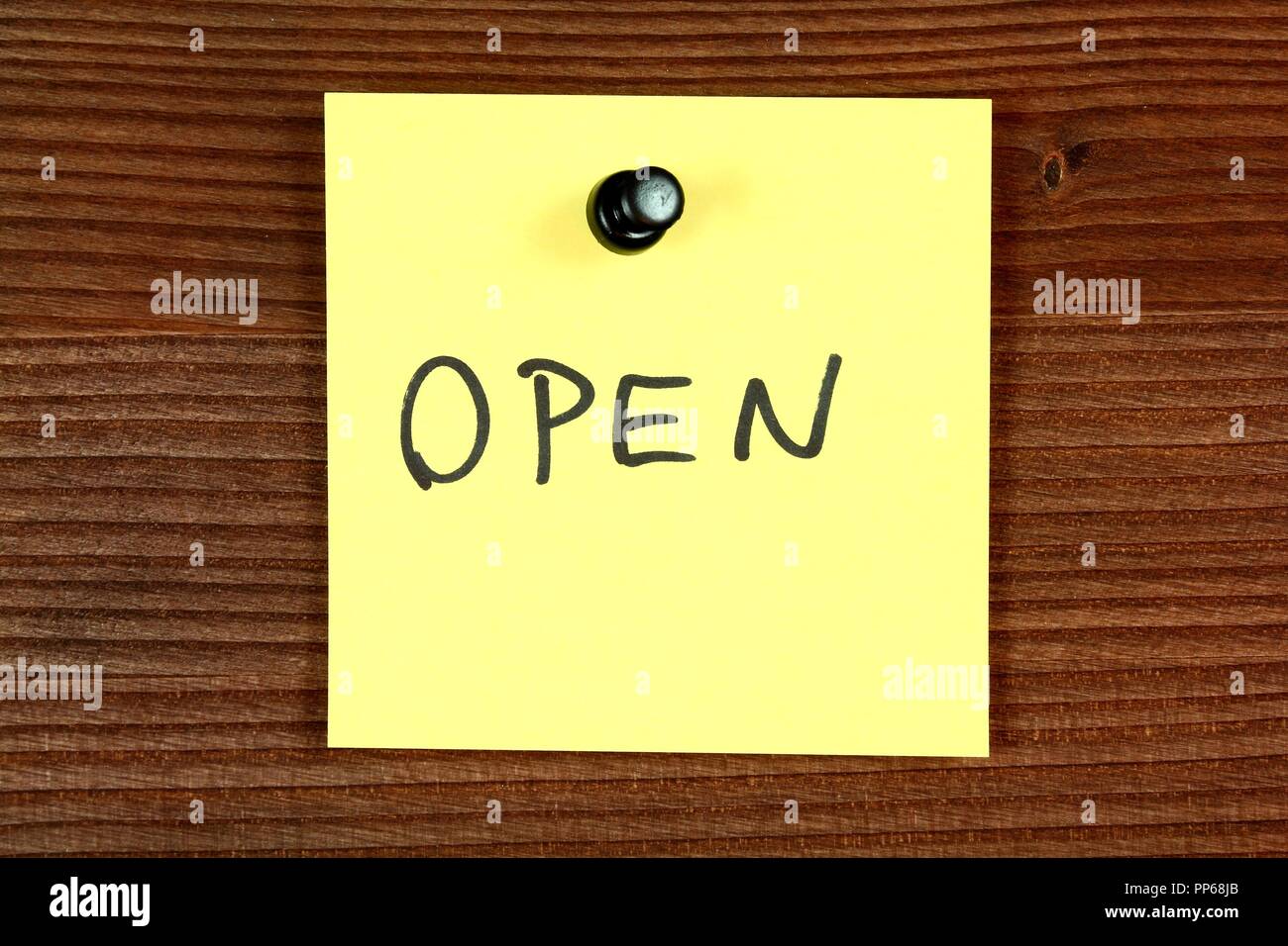 Yellow paper note with message open. Bulletin board Stock Photo Alamy