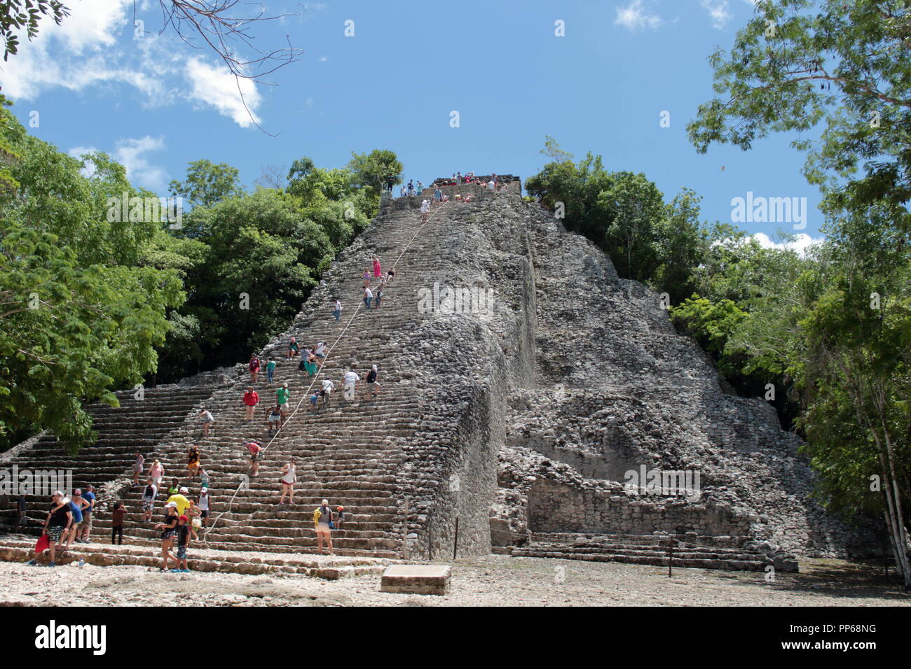 tourists who visit the archaeological site of Coba in Mexico with its beautiful 45-meter-high pyramid where climbing is at the risk of the tourist him Stock Photo