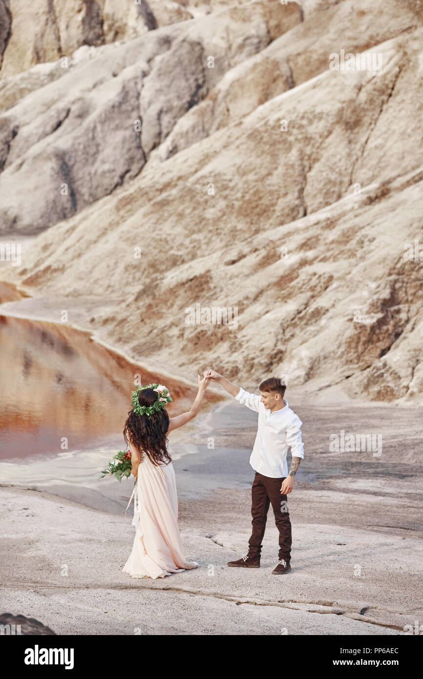 Bride And Groom Walk Along The Red Mountains Fabulous Scene