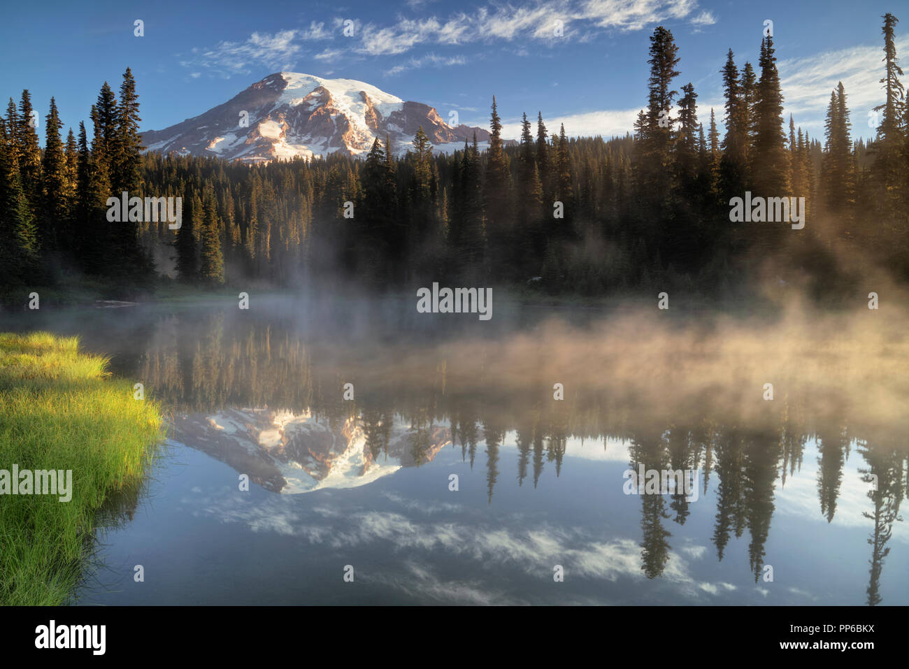First light glow on Washington’s Mt Rainier from the aptly named Reflection Lakes in Mount Rainier National Park. Stock Photo