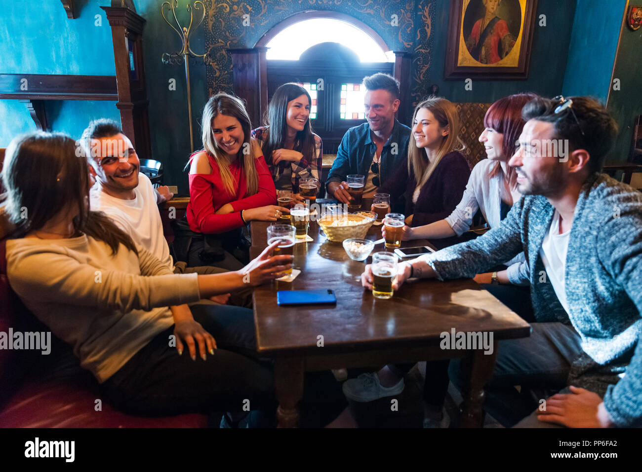 Group of happy friends having party in a bar - Young people drinking ...