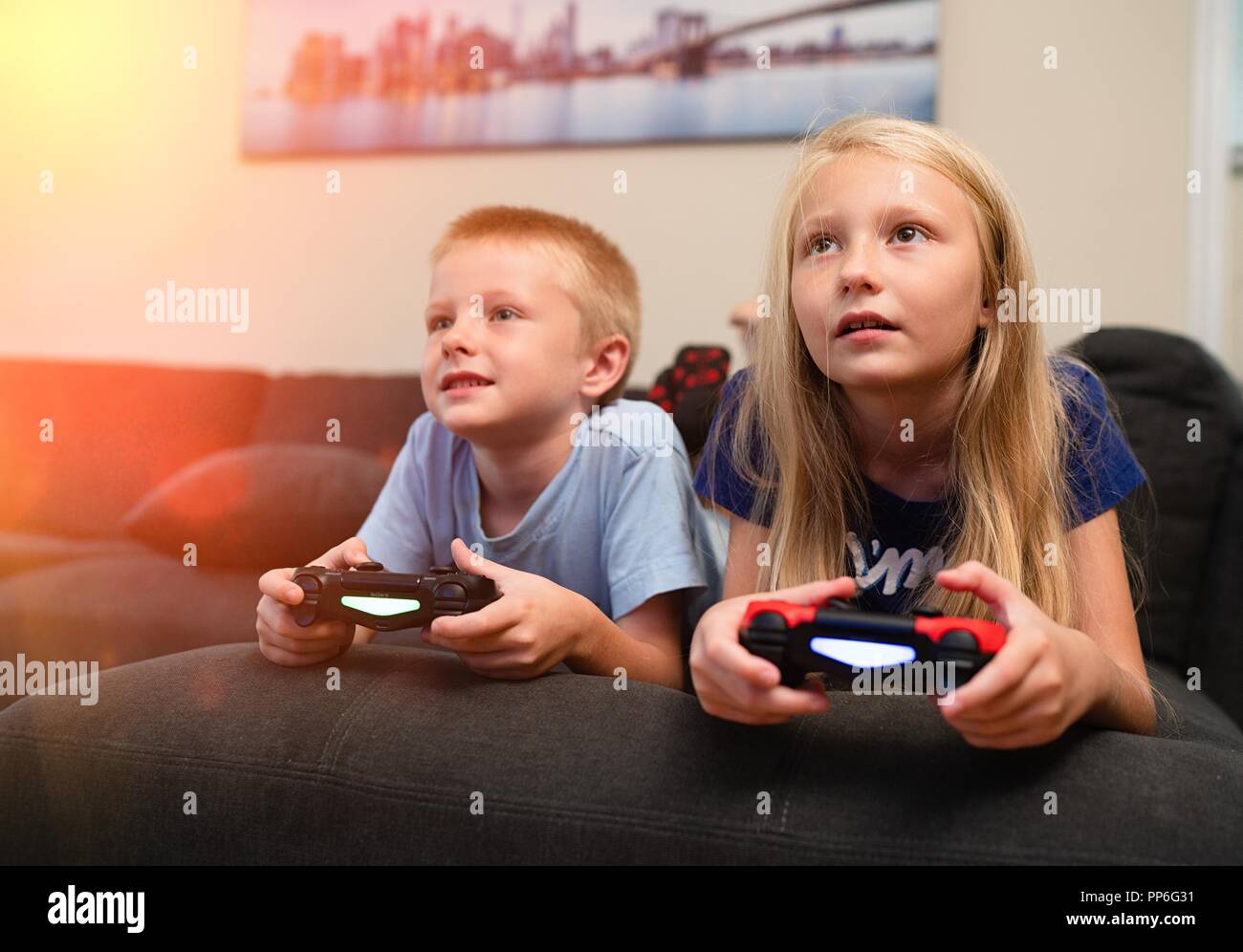 Young girl playing video games on computer after online school and  homework. Gamer using shooting action play for entertainment and fun with  keyboard and monitor. Child enjoying game Stock Photo - Alamy