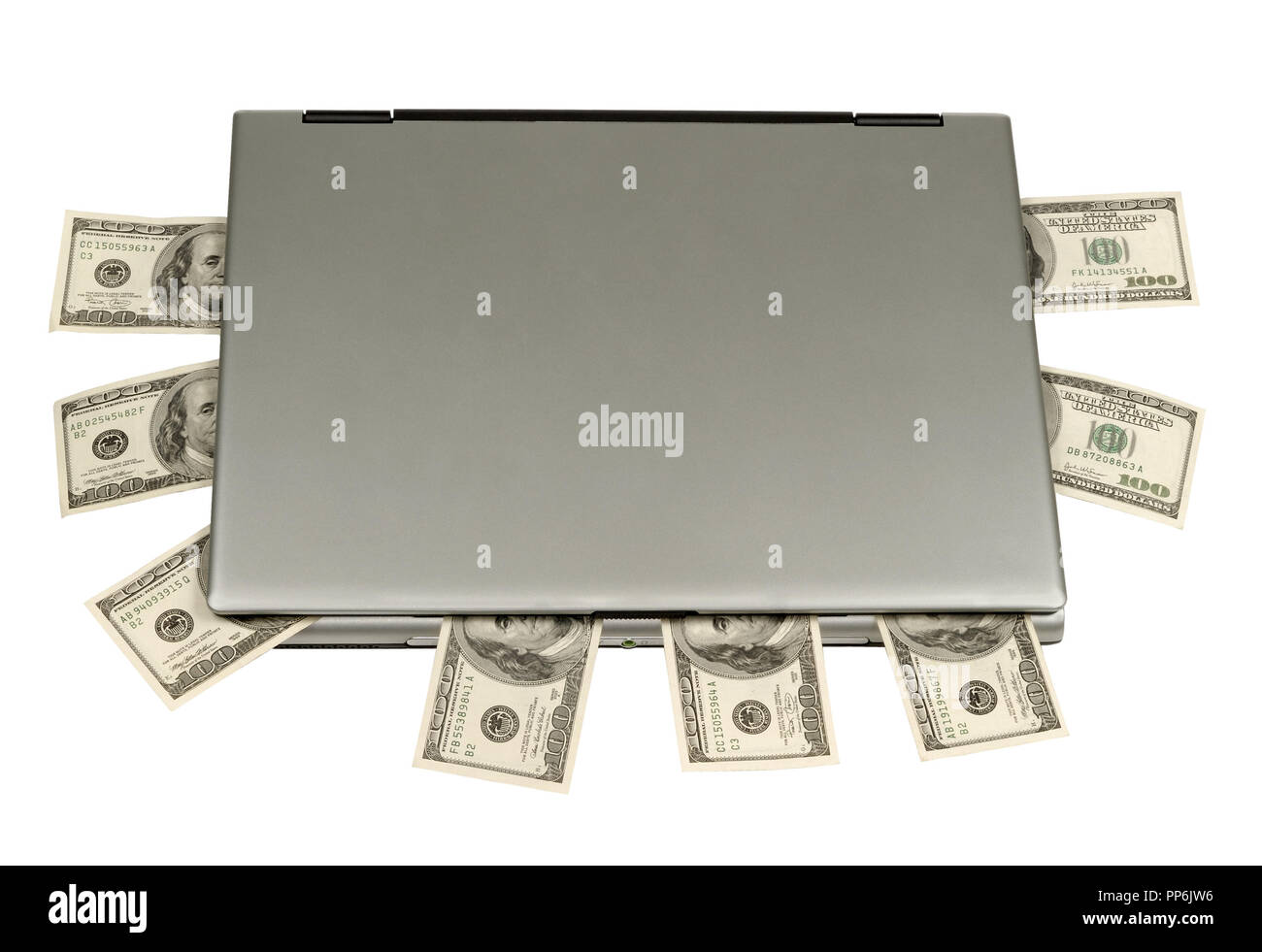Hundred-dollar banknotes lying on laptop, white background, isolated Stock Photo