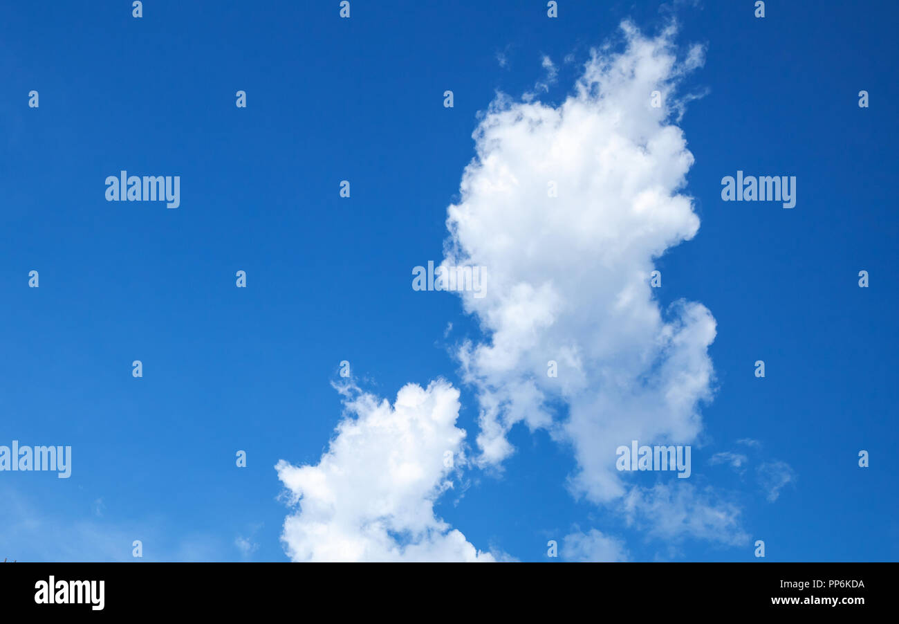 White cumulus clouds formation in clear blue sky, natural background photo Stock Photo