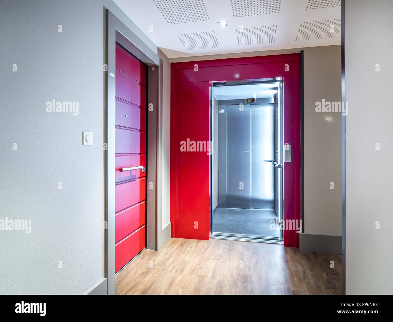 Front door of several flats and elevator in an apartment building Stock Photo