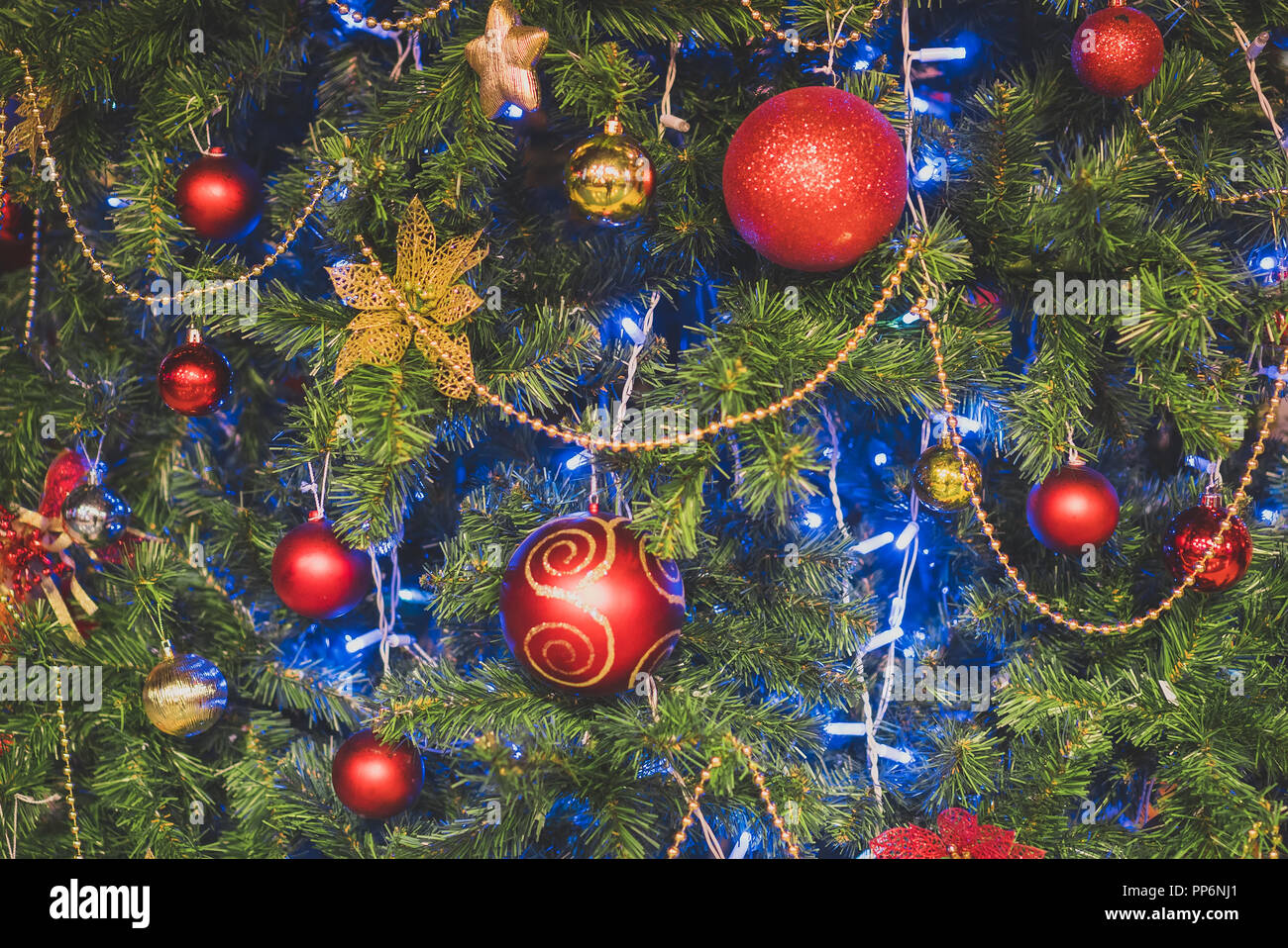 Artificial Christmas tree with garlands and balls Stock Photo - Alamy