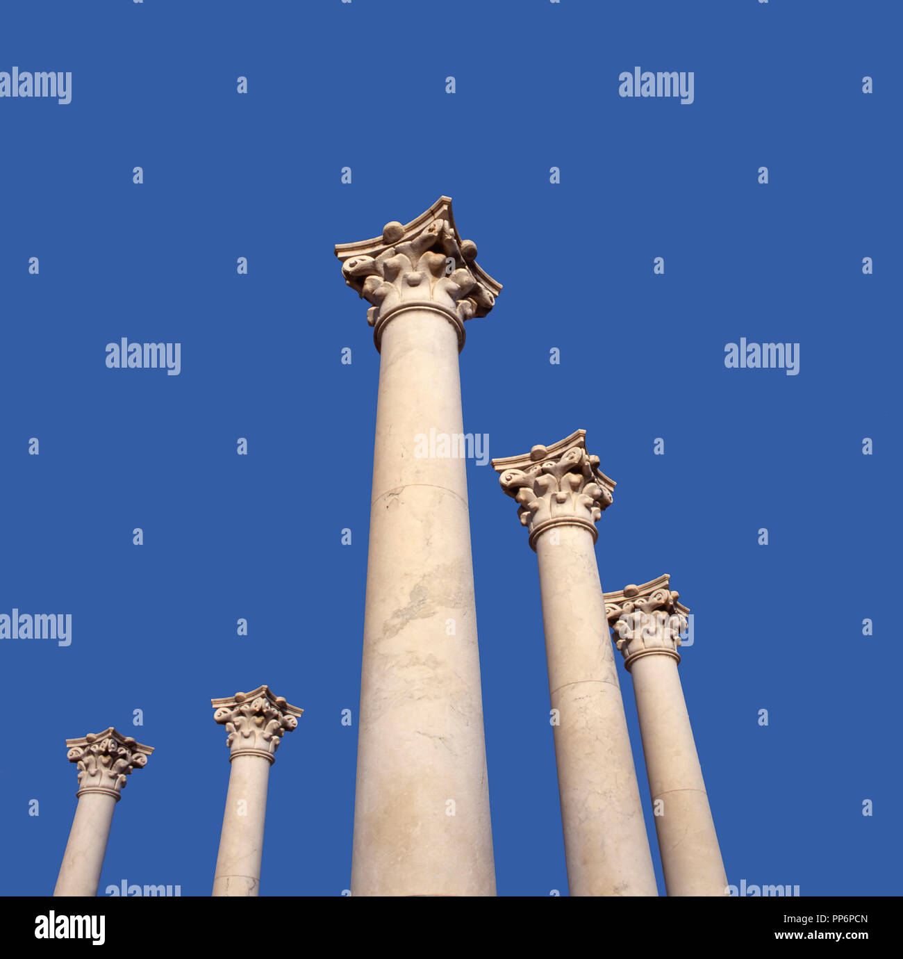 Five pillars against a clear blue sky at Ruins of Asclepeion on Kos island, Greece where Hippocrates received his medical training.This  ancient greek Stock Photo