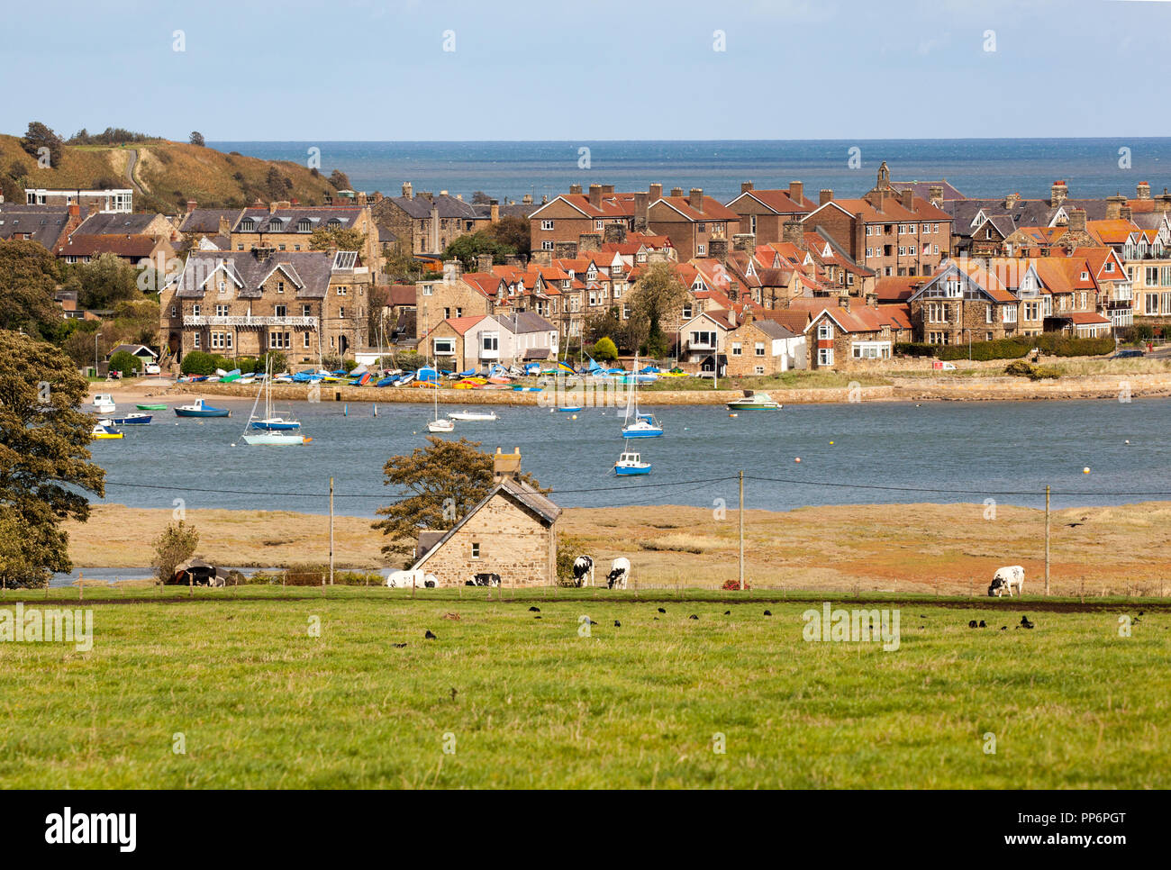 View across the estuary of the river Aln with fishing and sailing boats