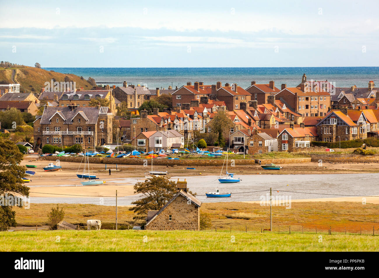 View across the estuary of the river Aln with fishing and sailing boats