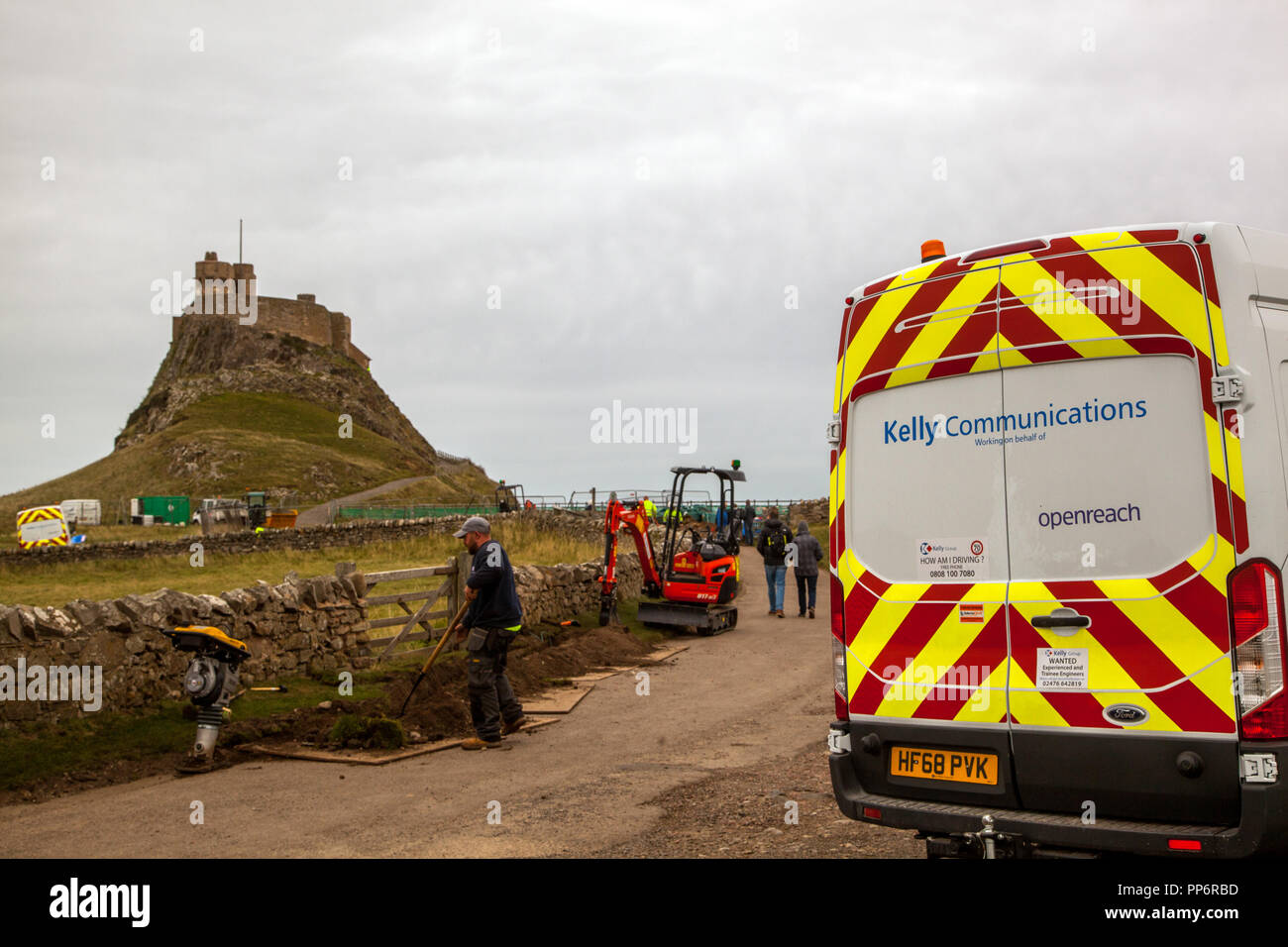 Openreach engineers installing high speed fibre optic broadband to the castle  on the Island of Lindisfarne or Holy Island Northumberland Englang UK Stock Photo