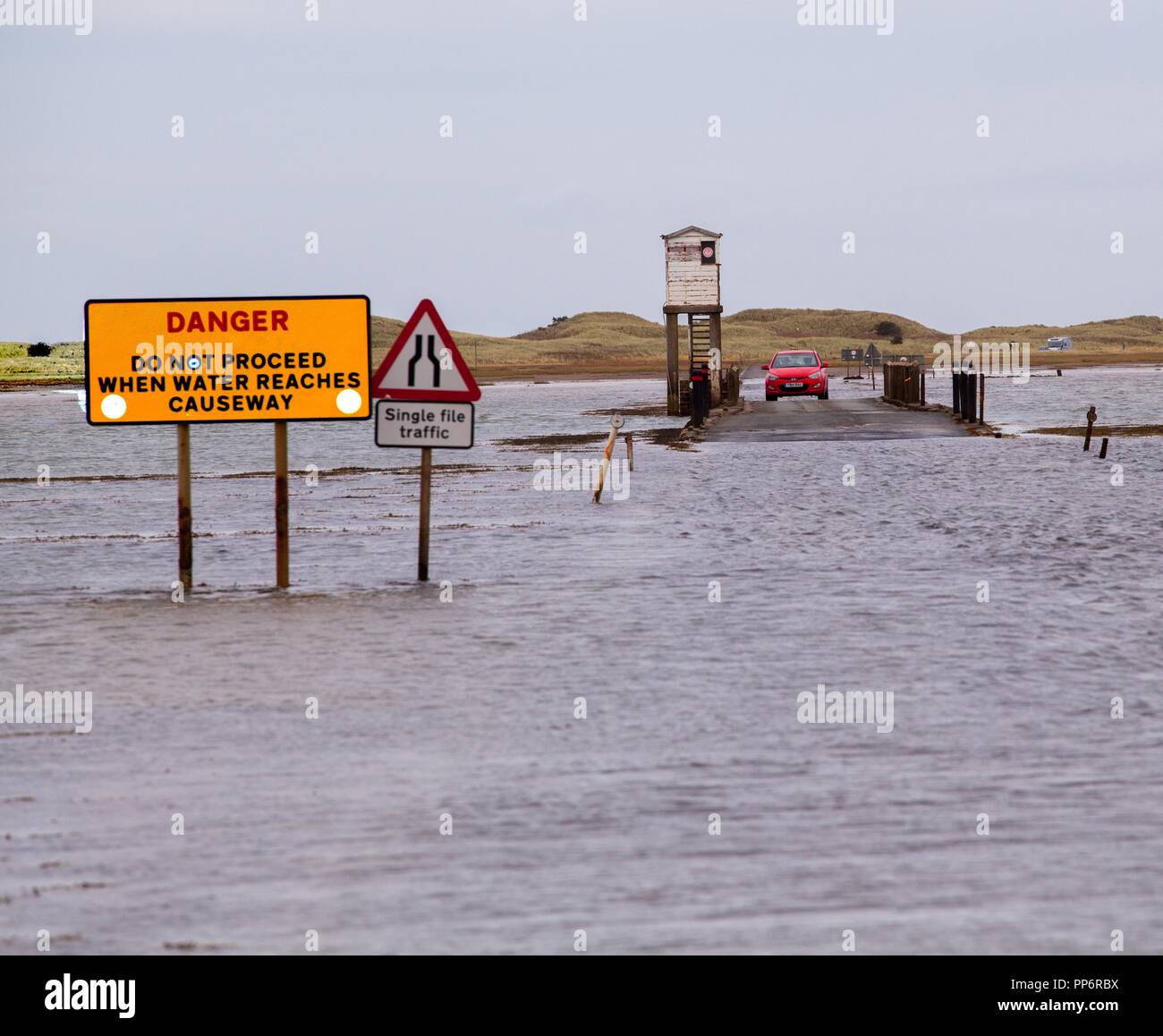 Car stranded on the refuge on the causeway from Holy Island or Lindisfarne after misjudging the incoming  tide, Northumberland England UK Stock Photo