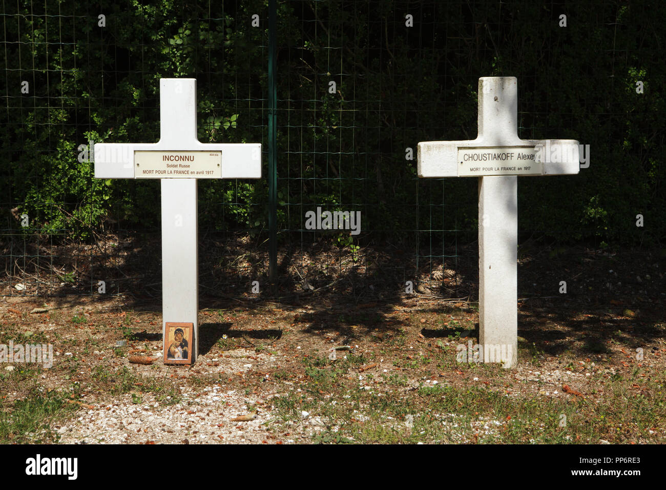 Graves of Russian soldiers fallen in France during the First World War at the Russian military cemetery (Cimetière militaire russe) in Saint-Hilaire-le-Grand near Mourmelon-le-Grand in Marne region in north-eastern France. Russian soldier Alexey Choustiakoff (also spelled Alexei Shustyakov) fallen in 1917 and an unidentified Russian soldier fallen in April 1917 are buried in the graves. Totally 915 Russian soldiers of the Russian Expeditionary Force fallen in France in 1916-1918 are buried at the cemetery. Stock Photo