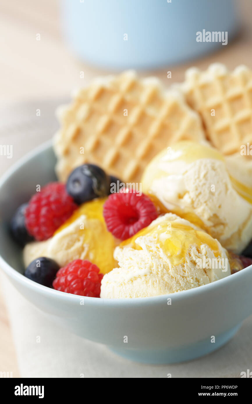 Ice cream with raspberry, blueberry, honey, and waffles Stock Photo Alamy