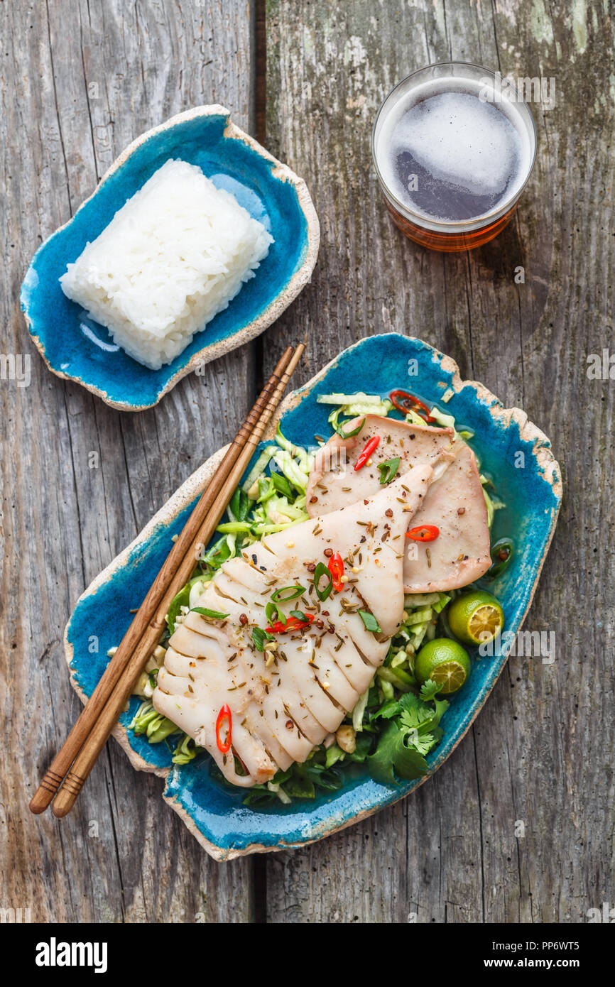 Squid salad with beer, flat lay, top view Stock Photo