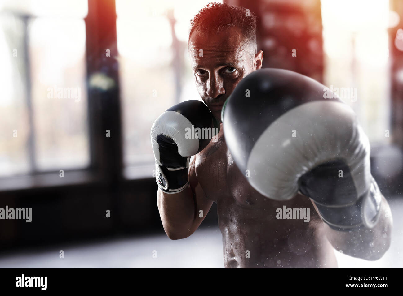 Man does boxing workouts at the gym Stock Photo