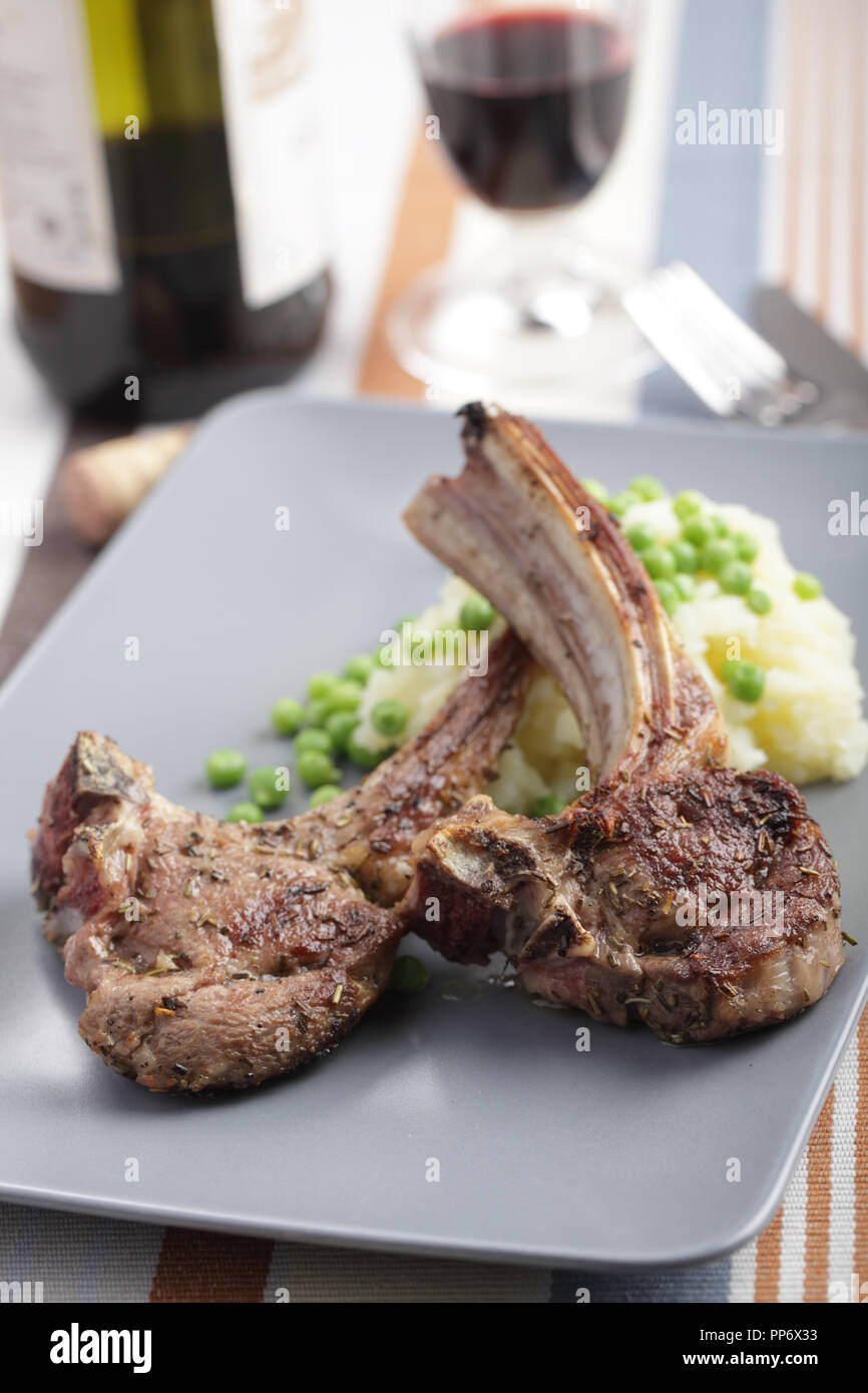 Lamb cutlets with mashed potato and green peas Stock Photo