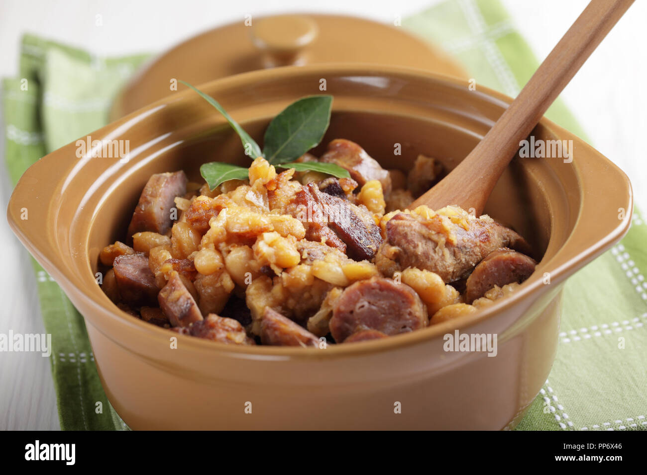 Cassoulet with goose meat, pork sausage, and beans in the pot Stock Photo