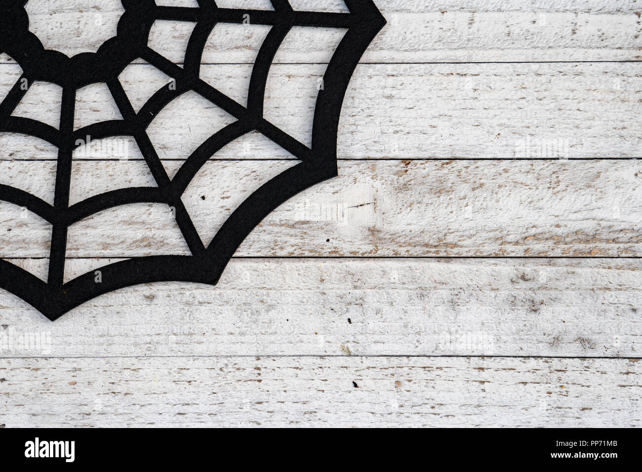 Rustic black spiderweb Halloween background concept on wood background. Copy space available Stock Photo