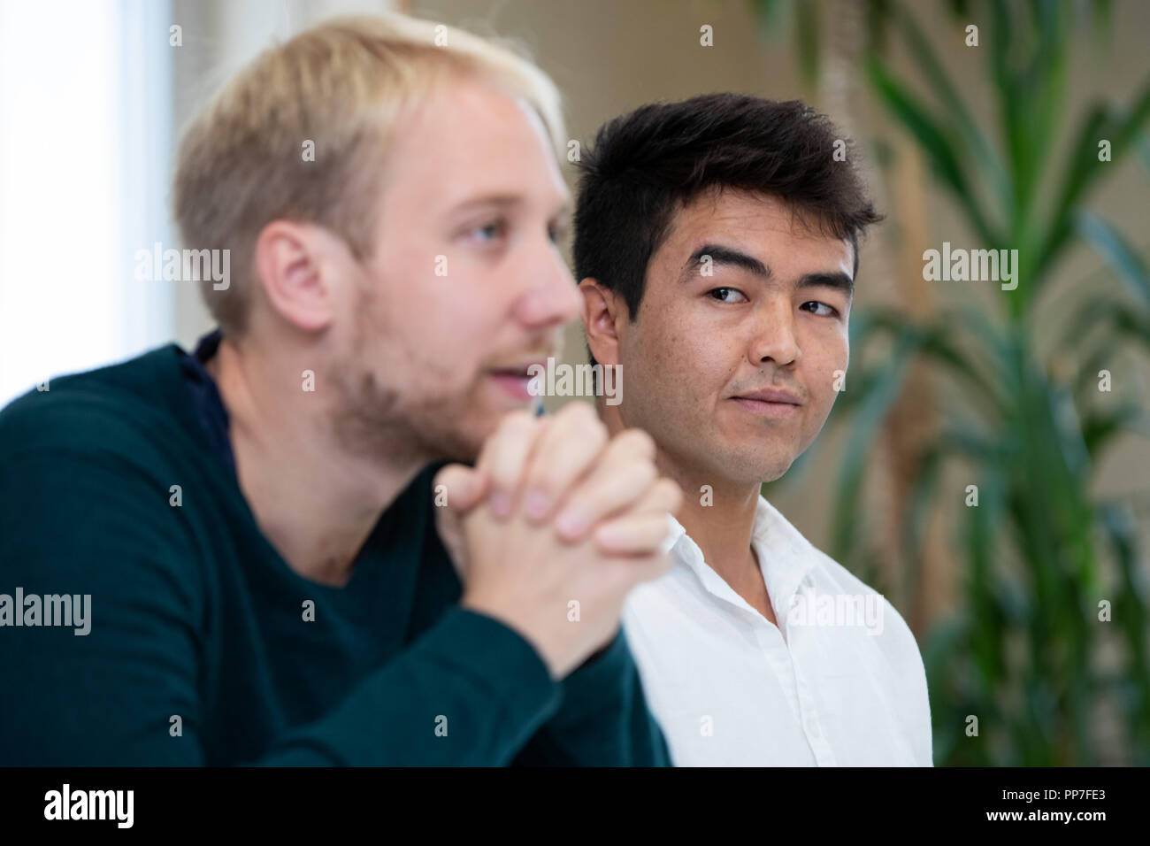 24 September 2018, Bavaria, Nuernberg: Michael Brenner (l), lawyer, speaking alongside his client Asif N., a refugee from Afghanistan, during a press conference on the occasion of a pending trial after a tumultuous deportation attempt. On May 31, 2017, the then 20-year-old was to be taken into deportation custody from a Nuremberg vocational school. The deployment had attracted attention and criticism nationwide. Asif N., who is on trial this Wednesday, 26.09.2018, after a tumultuous deportation attempt in Nuremberg, still hopes for a right of residence in Germany. Photo: Daniel Karmann/dpa Stock Photo