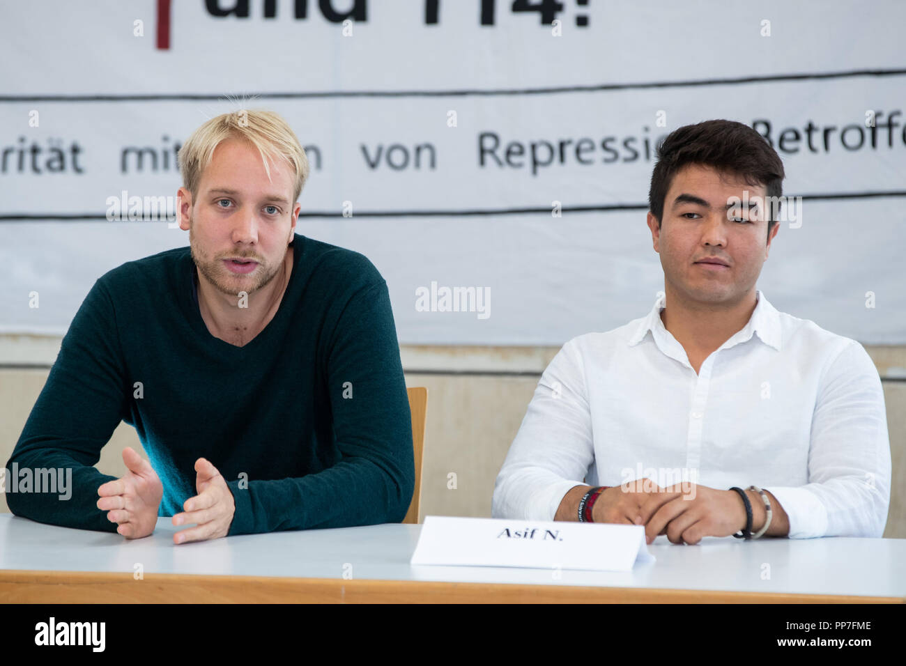 24 September 2018, Bavaria, Nuernberg: Michael Brenner (l), lawyer, speaking alongside his client Asif N., a refugee from Afghanistan, during a press conference on the occasion of a pending trial after a tumultuous deportation attempt. On May 31, 2017, the then 20-year-old was to be taken into deportation custody from a Nuremberg vocational school. The deployment had attracted attention and criticism nationwide. Asif N., who is on trial this Wednesday, 26.09.2018, after a tumultuous deportation attempt in Nuremberg, still hopes for a right of residence in Germany. Photo: Daniel Karmann/dpa Stock Photo