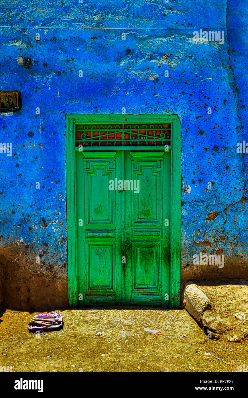 Green doors on a typical colorful house near Medinet Habu in Luxor, Egypt Stock Photo