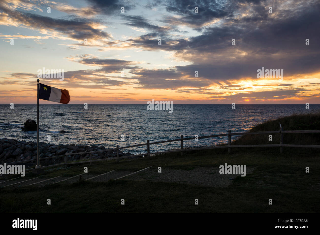 Acadian flag at sunset in L'EtangduNord on Grindstone Island in the