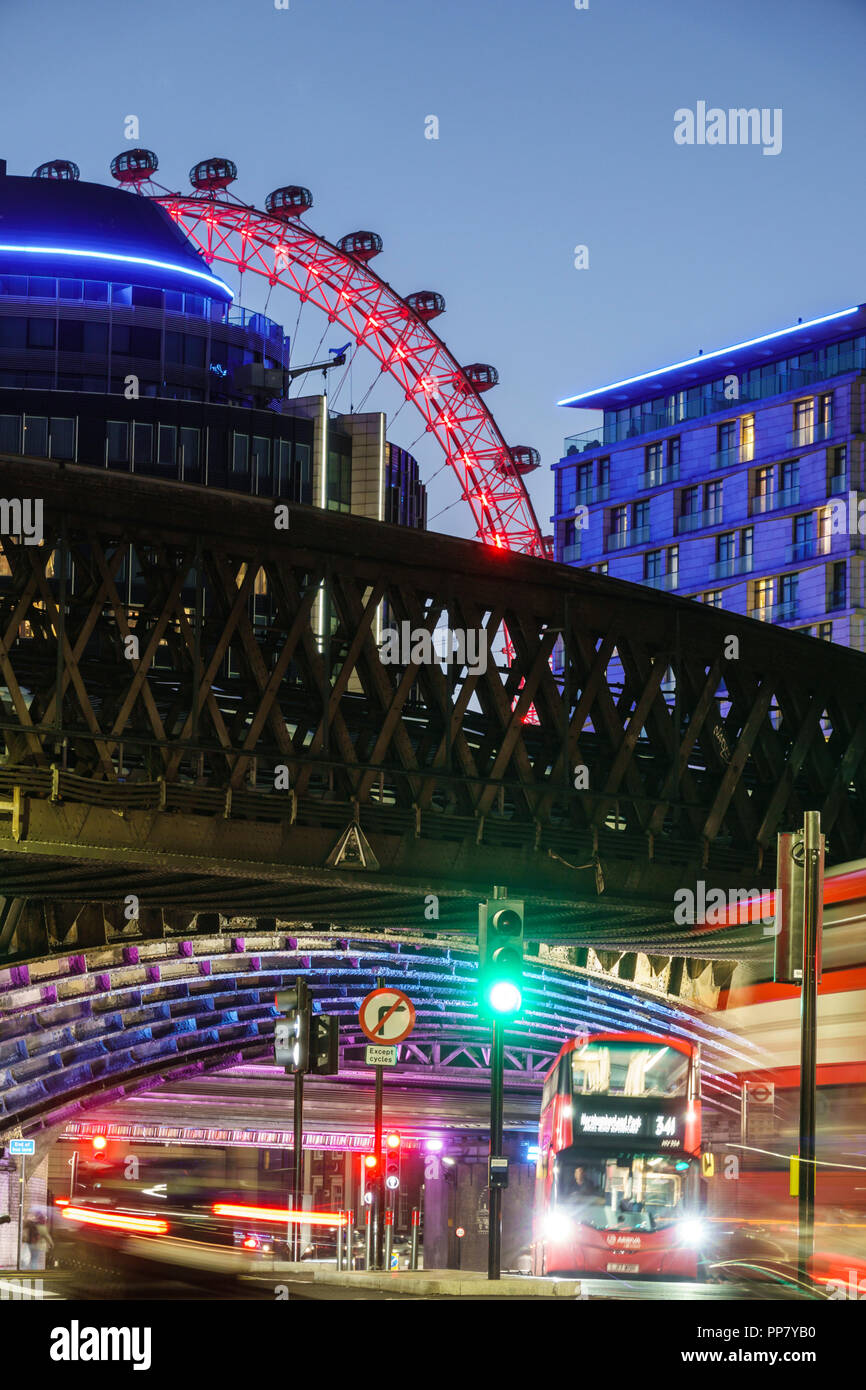 London England,UK,South Bank,Lambeth,Westminster Bridge Road,London Eye,night dusk,city skyline,light streaks,motion,red double-decker bus,green traff Stock Photo