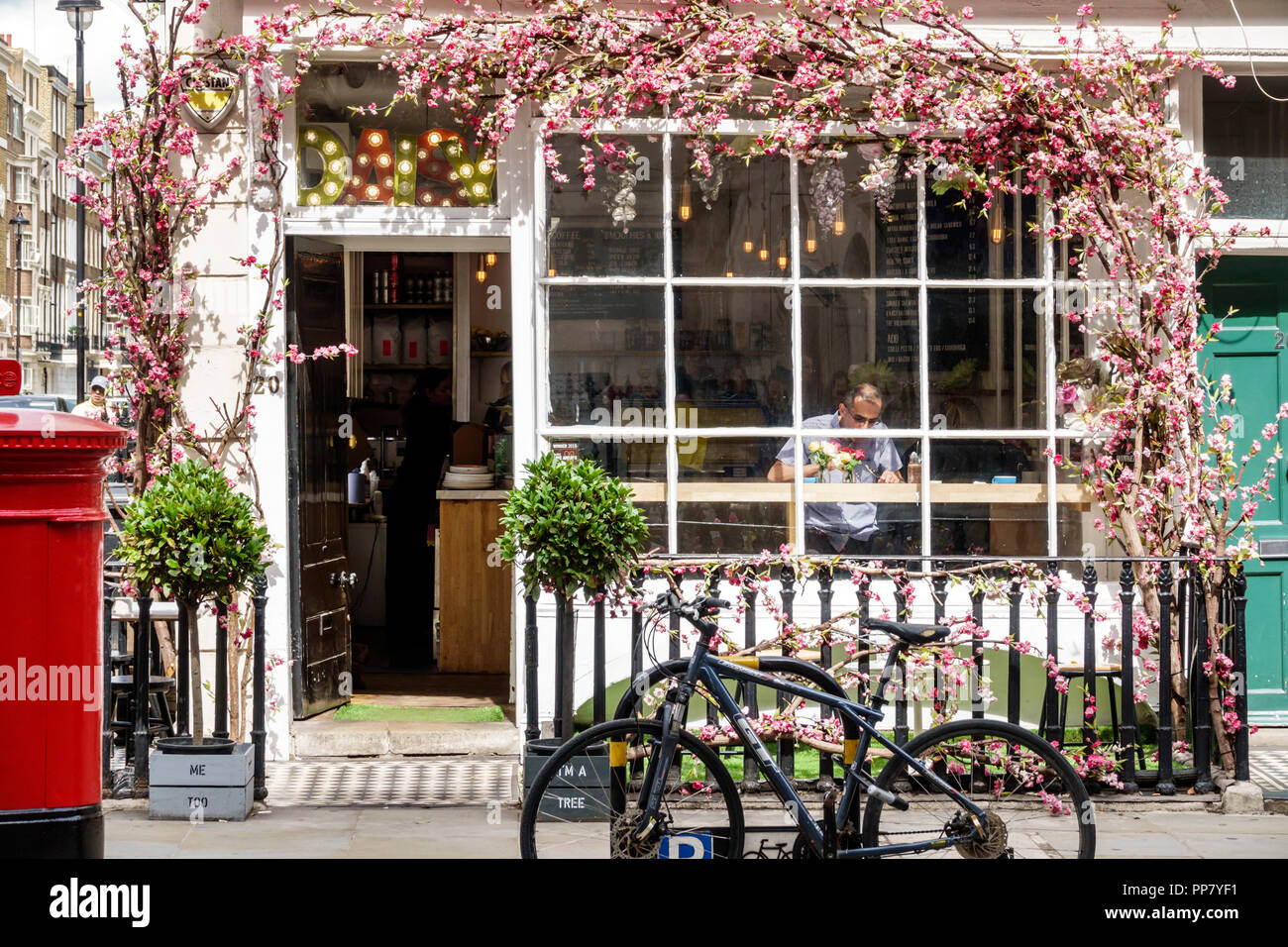 London England,UK,Marylebone,Daisy Green,cafe,artisan coffee shop,window,exterior,bicycle bicycles bicycling riding biking rider riders bike bikes,mai Stock Photo