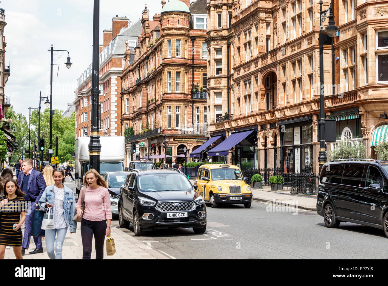 London England,UK,West End City Westminster Mayfair,South Audley Street,historic buildings,shops,pedestrians,woman female women,taxi,UK GB English Eur Stock Photo