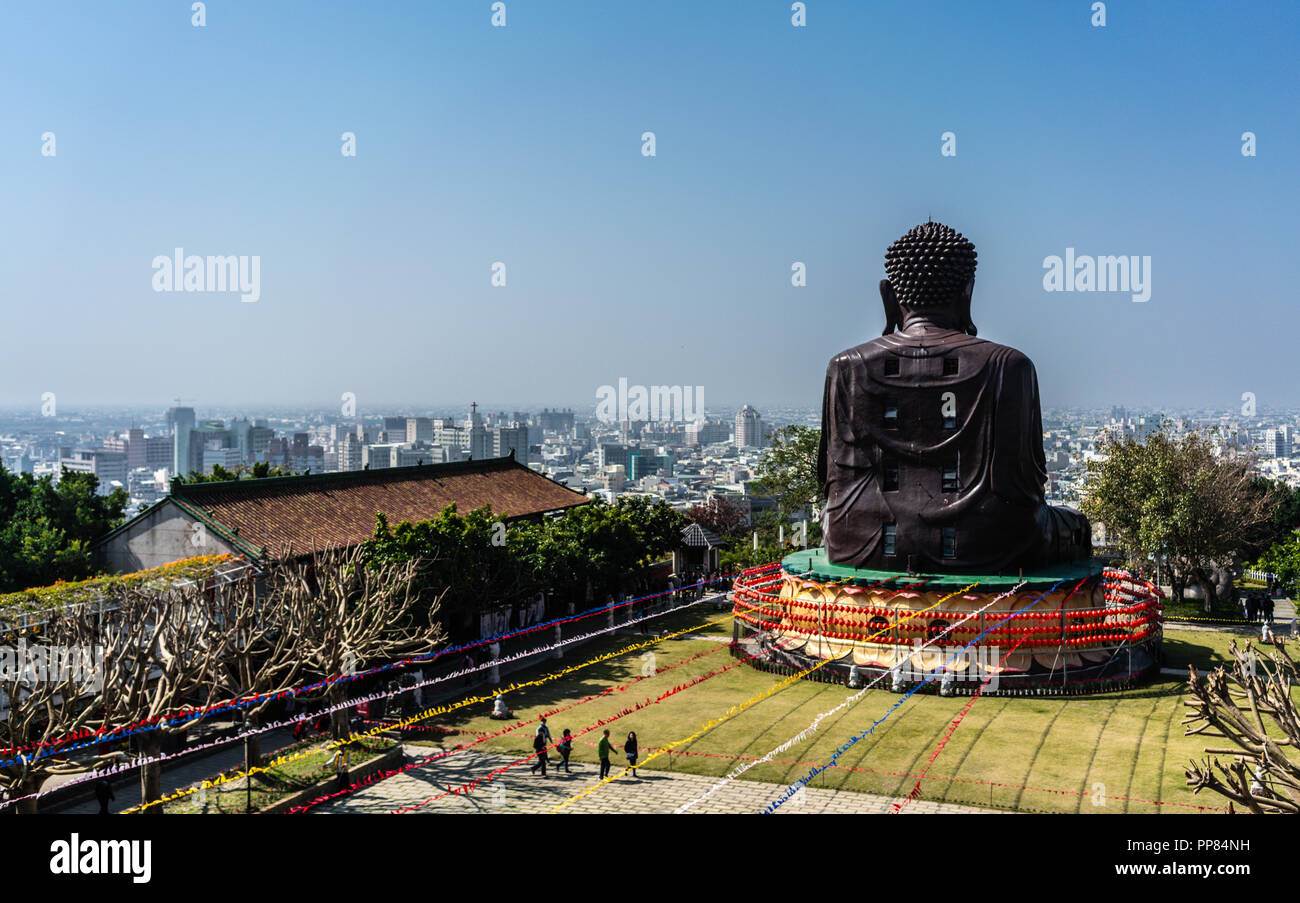 back of Baguashan great Buddha statue from mount Bagua and Changhua cityscape panorama in background in Taiwan Stock Photo